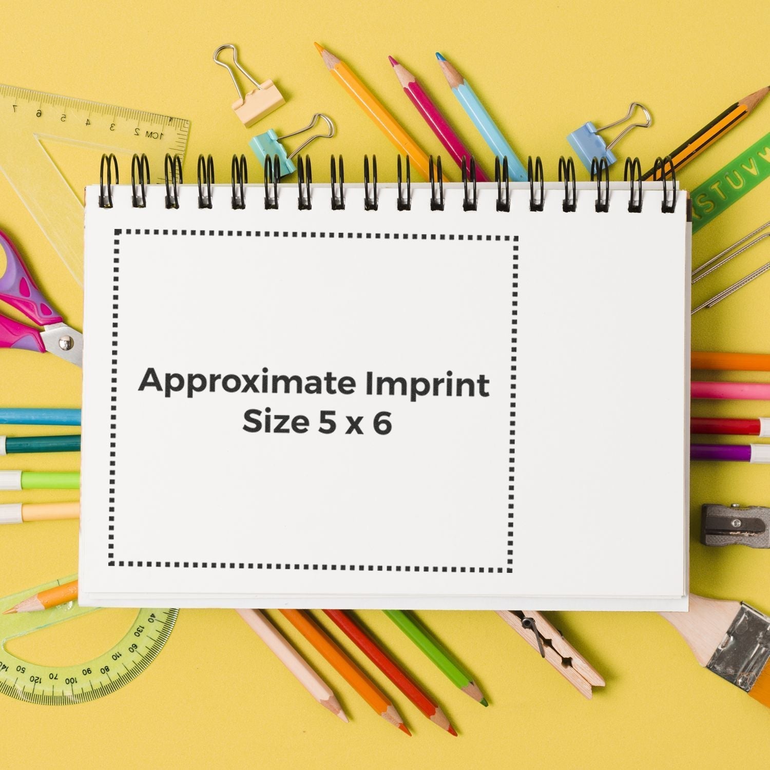 Custom Rubber Stamp Size 5 x 6 displayed on a white notepad surrounded by colorful stationery on a yellow background.