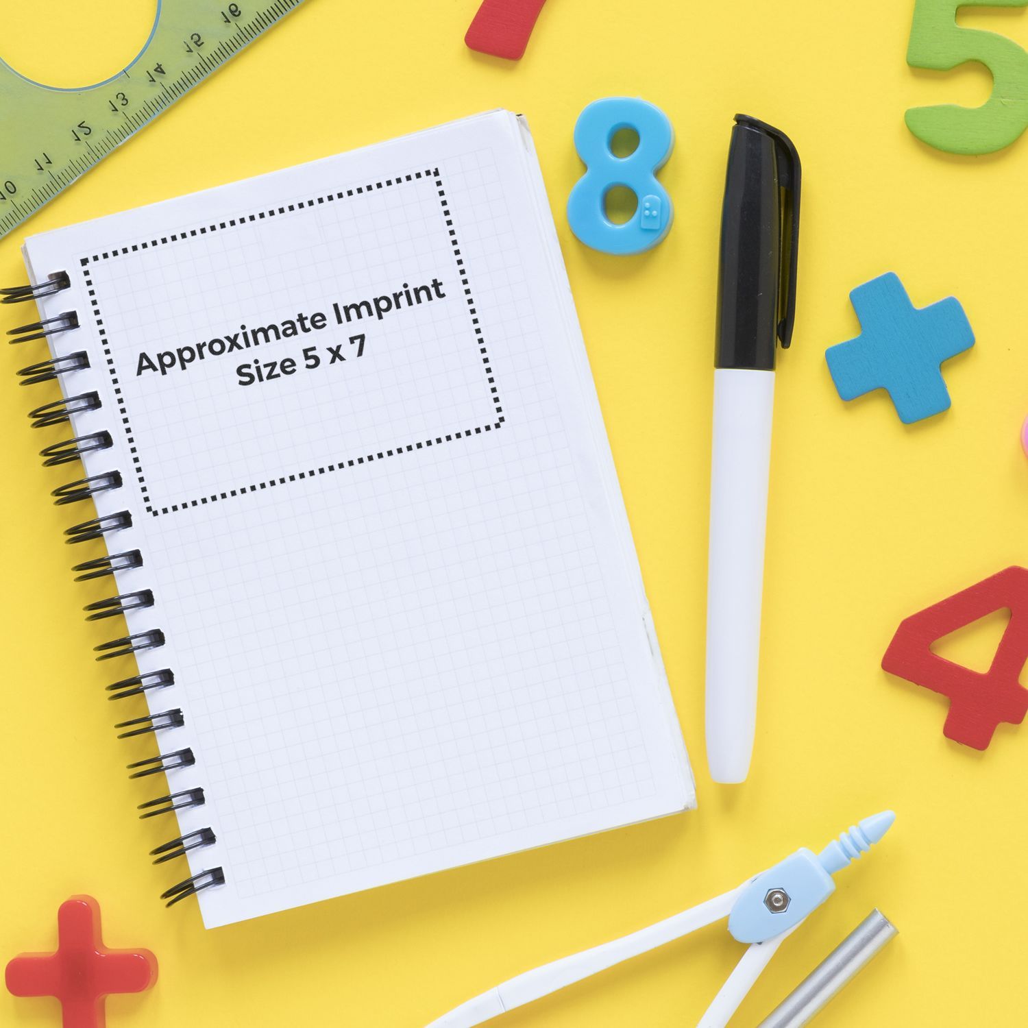 Custom Rubber Stamp Size 5 x 7 displayed on a notebook with a pen, ruler, and colorful numbers and shapes on a yellow background.