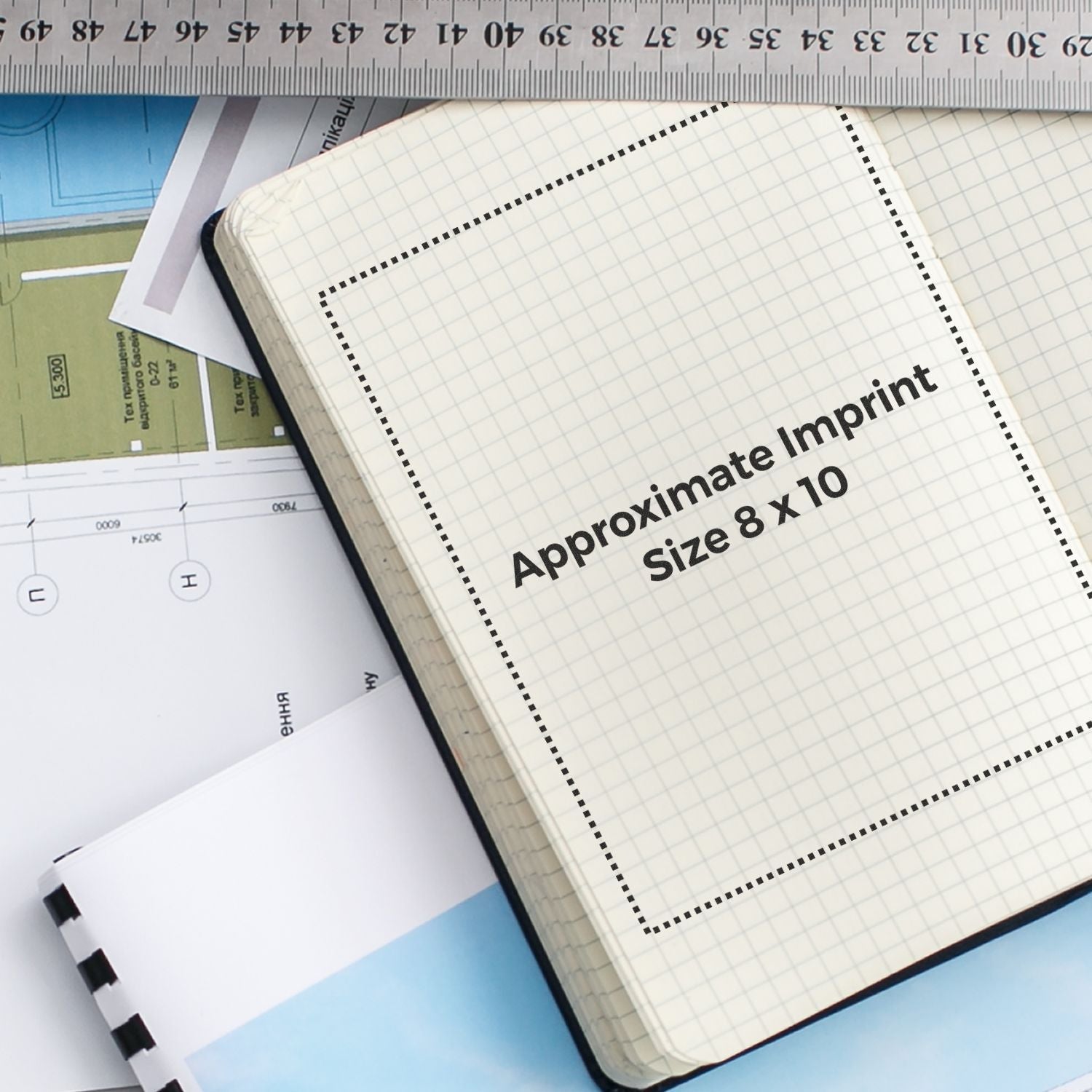 Custom Rubber Stamp Size 8 x 10 shown on a grid notebook with a ruler and papers in the background.