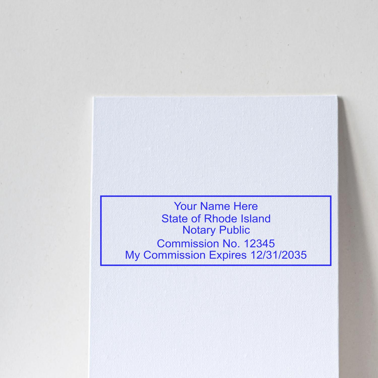 This paper is stamped with a sample imprint of the Wooden Handle Rhode Island Rectangular Notary Public Stamp, signifying its quality and reliability.