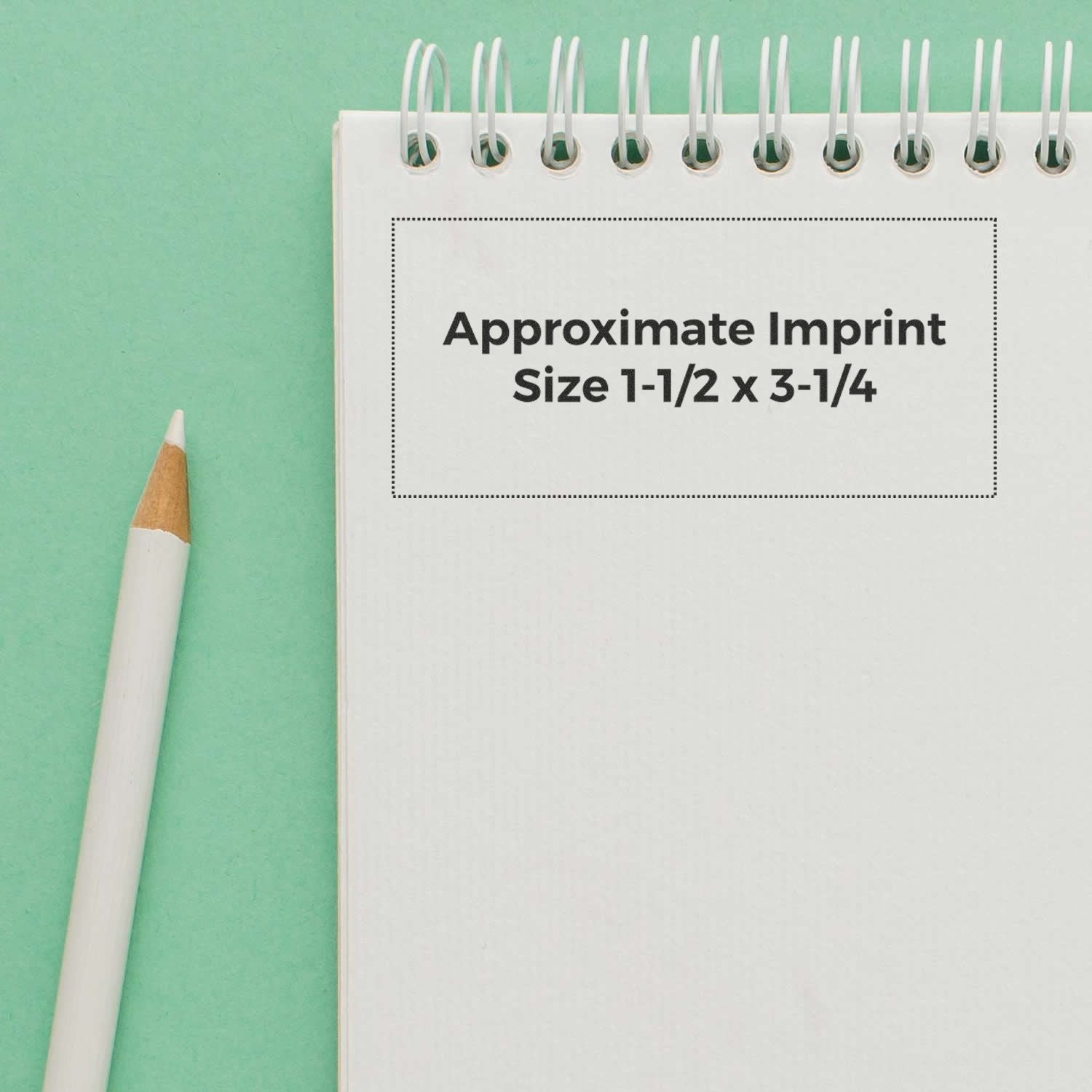 Slim Stamp 3679 Customized Pre-Inked Stamp 1-7/16 x 3-1/8 shown on a spiral notebook with a pencil on a green background.