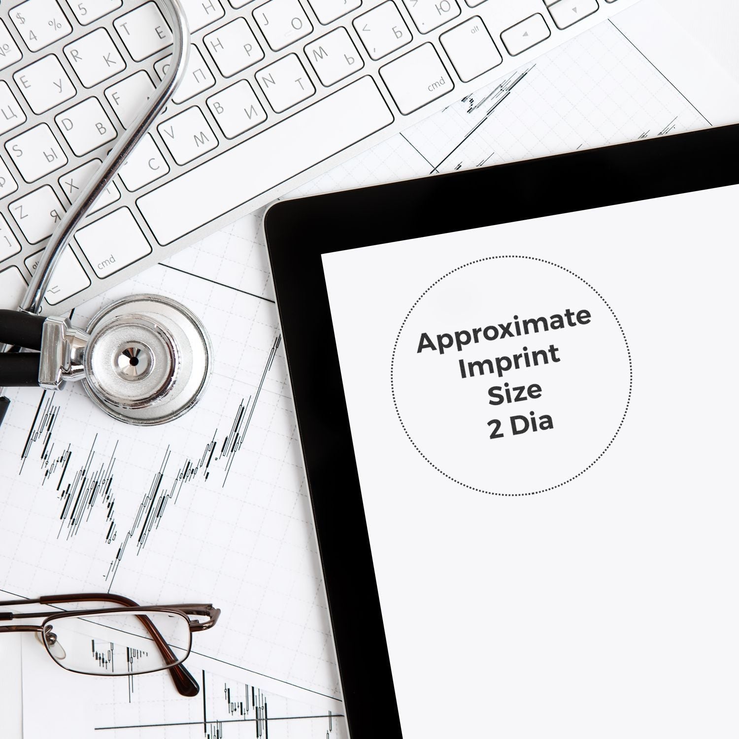 Slim Stamp 50R Customized Pre-Inked Stamp 2 Diameter shown on a tablet screen, surrounded by a keyboard, stethoscope, and glasses.