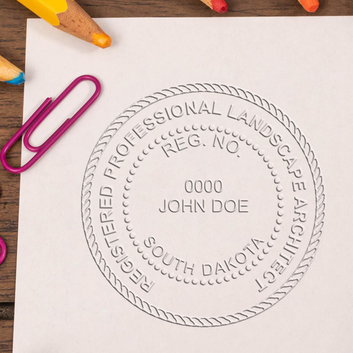 An in use photo of the Hybrid South Dakota Landscape Architect Seal showing a sample imprint on a cardstock