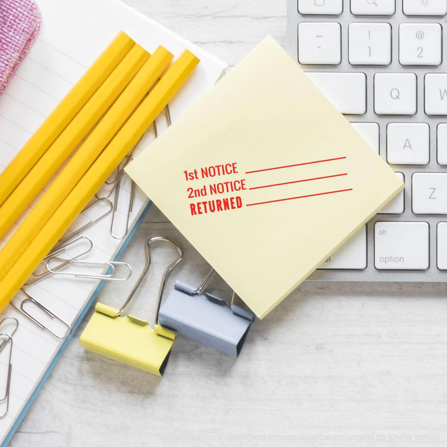 Large Pre-Inked 1st 2nd Notice Returned Stamp on a yellow sticky note, surrounded by office supplies and a keyboard.