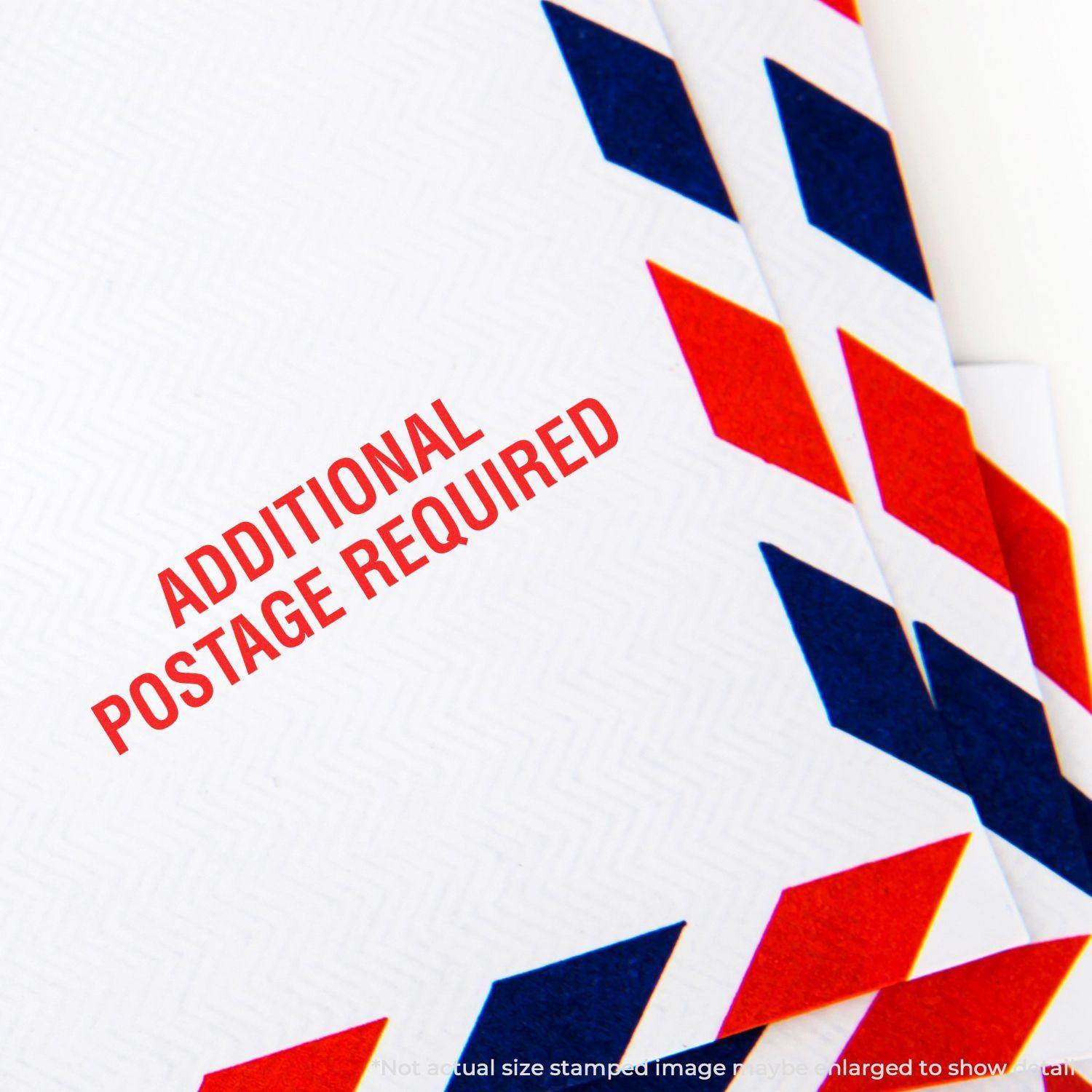Additional Postage Required rubber stamp on white envelope with red and blue chevron border, indicating extra postage needed.