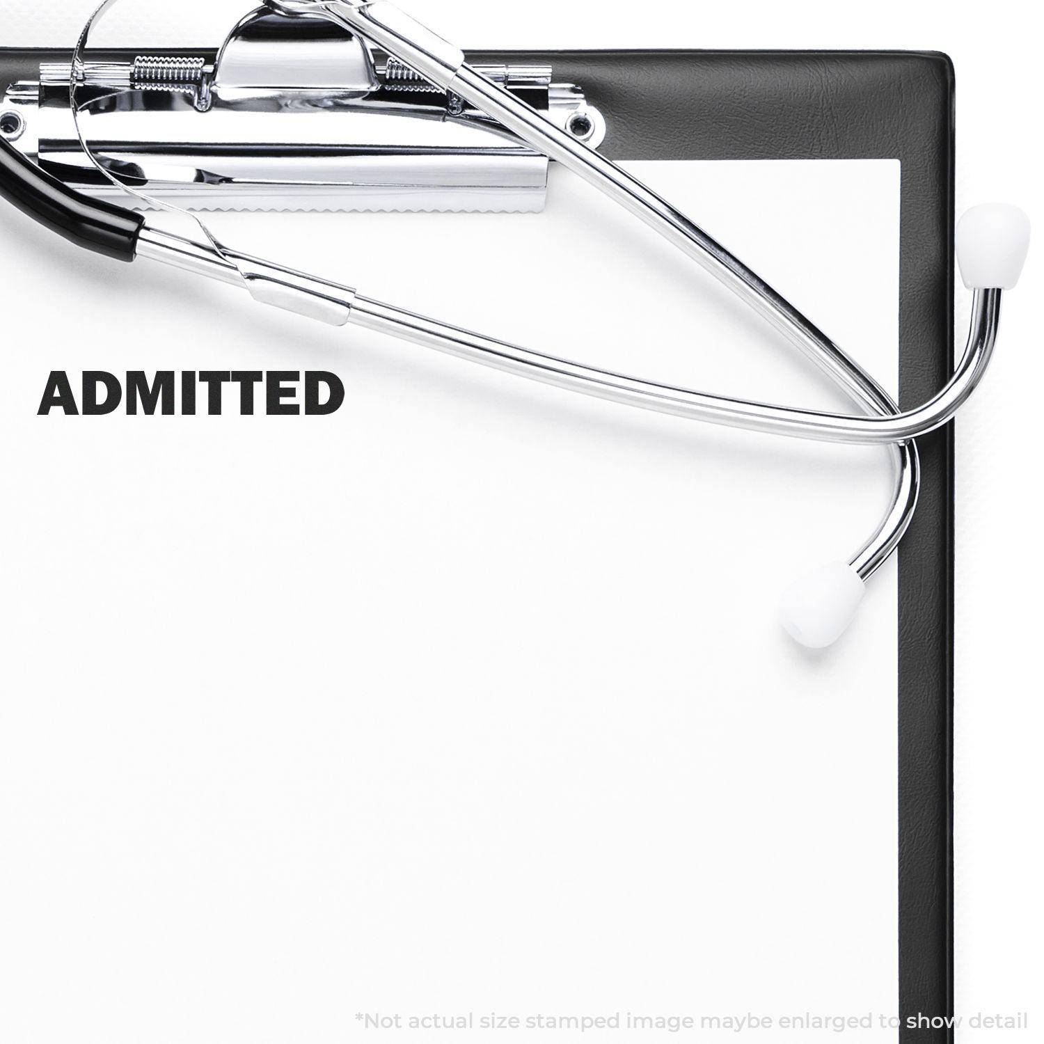 Clipboard with a stethoscope and a Large Self Inking Admitted Stamp marking ADMITTED on a white paper.