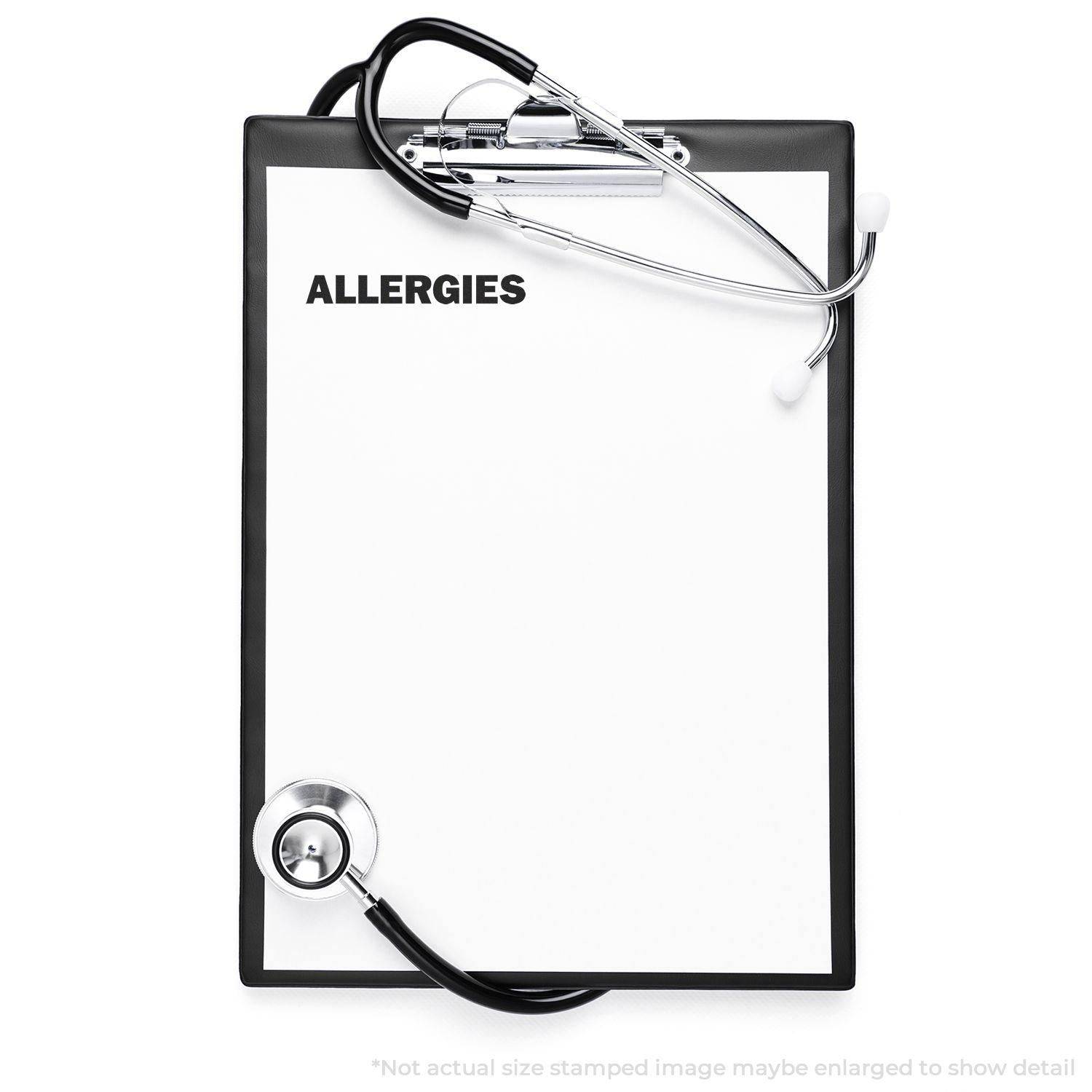 Clipboard with ALLERGIES stamped on paper using the Large Pre-Inked Allergies Stamp, with a stethoscope placed on top.