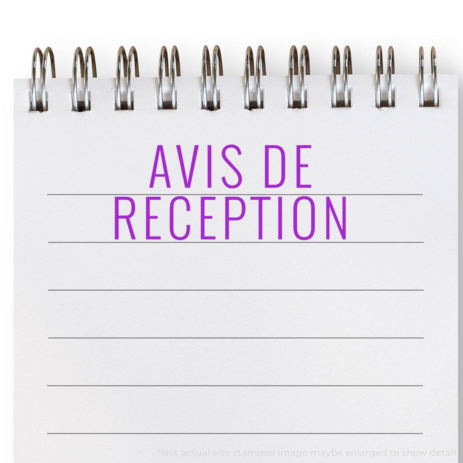 Large Self Inking Avis De Reception Stamp in purple ink on a spiral-bound notepad with lined paper.