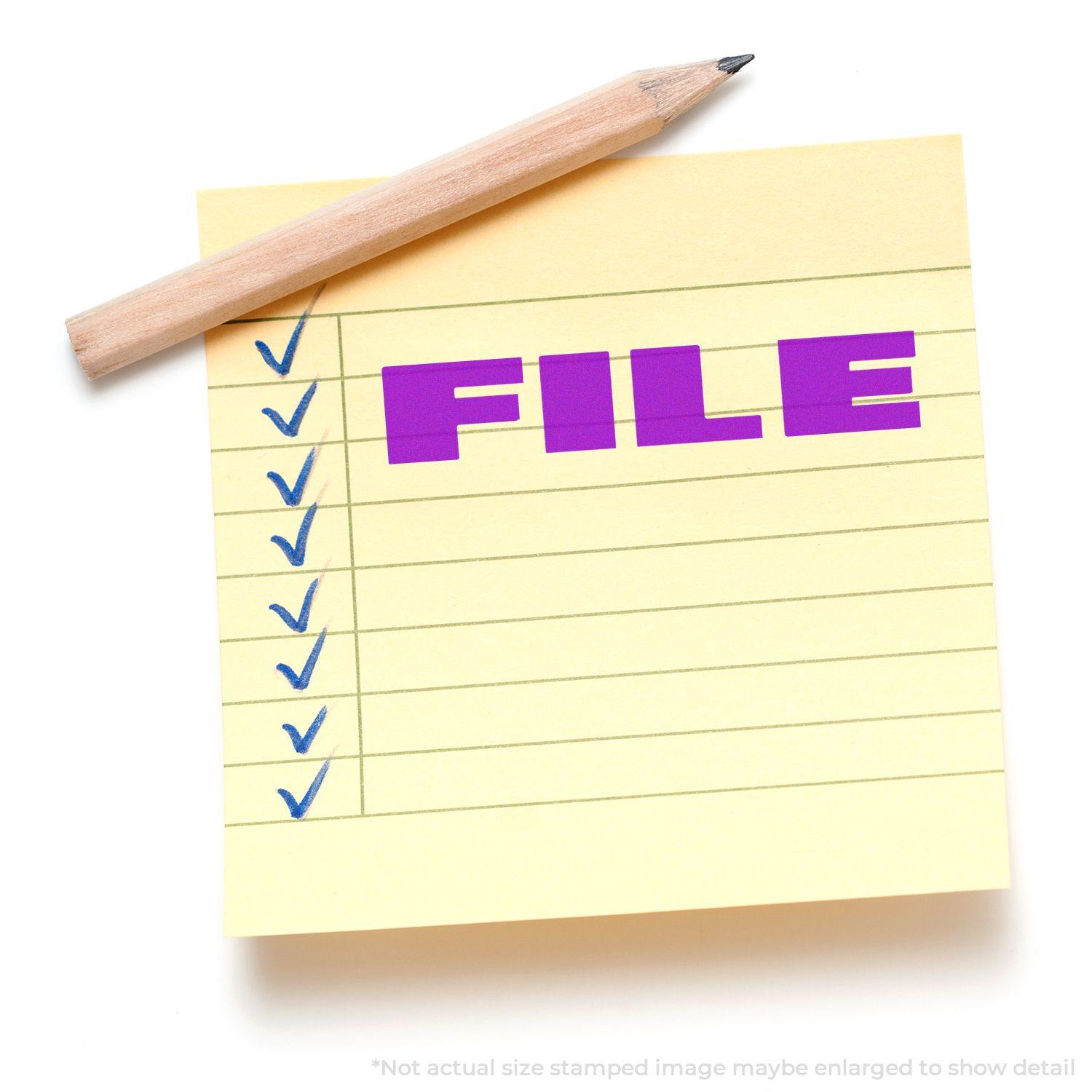 Yellow sticky note with blue checkmarks and a bold font FILE rubber stamp in purple, with a pencil resting on top.