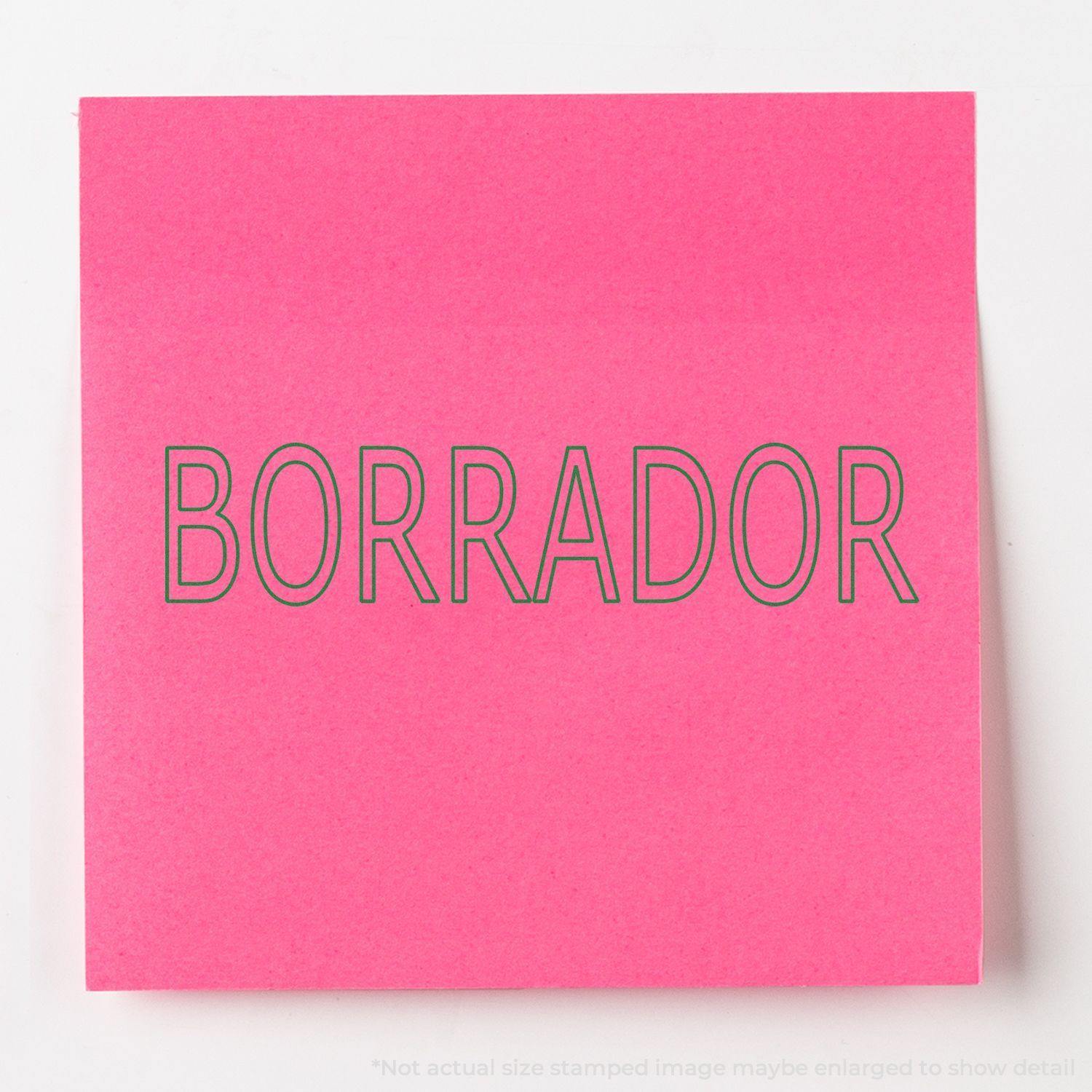 Slim Pre-Inked Borrador Stamp impression on a bright pink sticky note with bold, clear text.