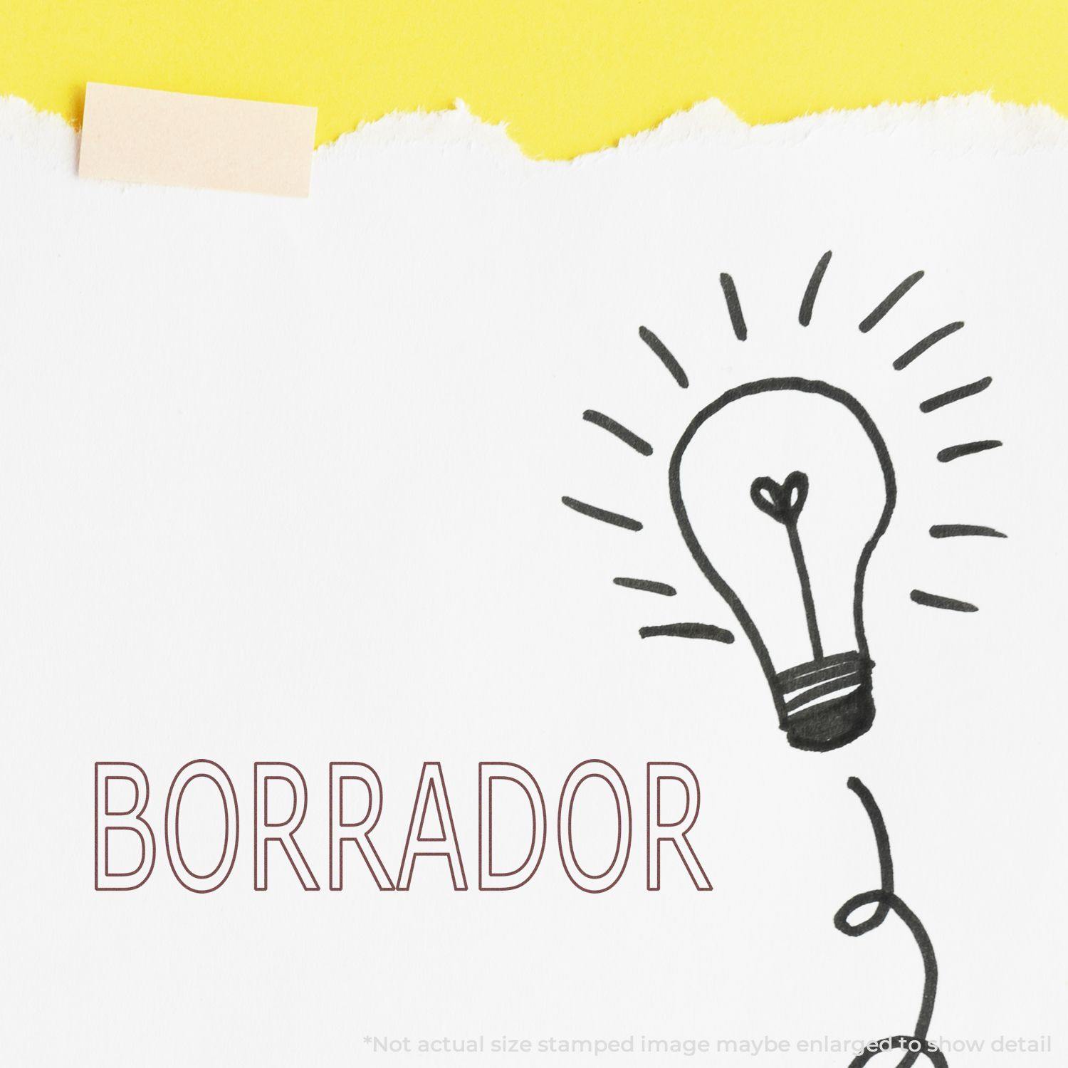 Slim Pre-Inked Borrador Stamp on white paper with a hand-drawn light bulb and yellow background.