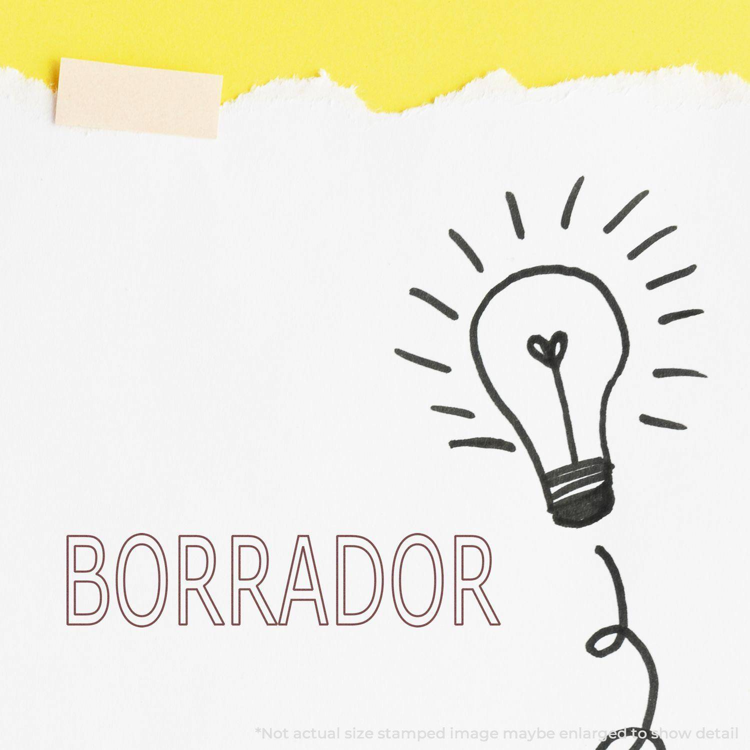 Large Pre-Inked Borrador Stamp used on white paper with a lightbulb drawing and yellow background.