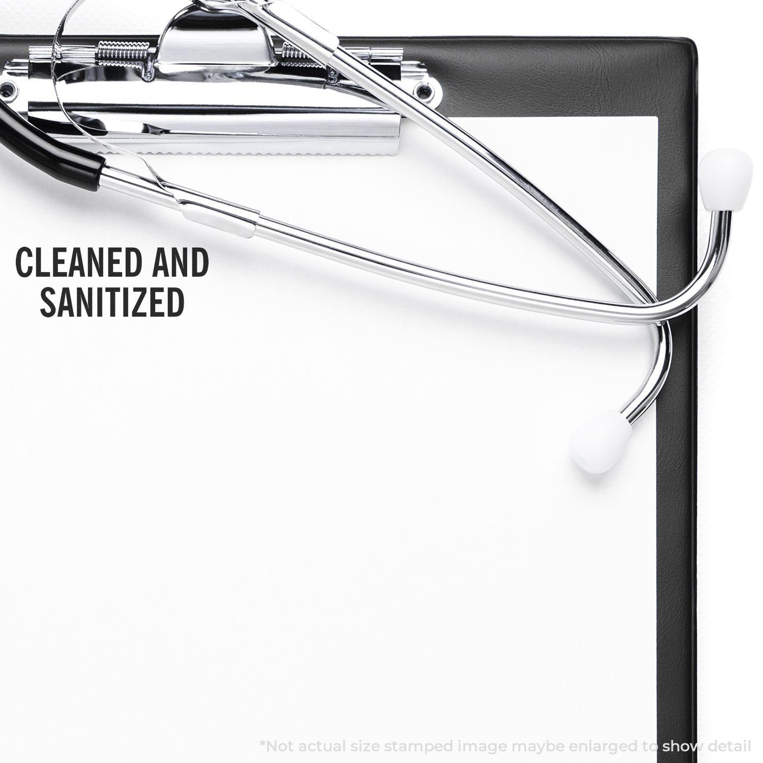 Slim Pre-Inked Cleaned and Sanitized Stamp used on a clipboard with a stethoscope, indicating cleanliness and hygiene.