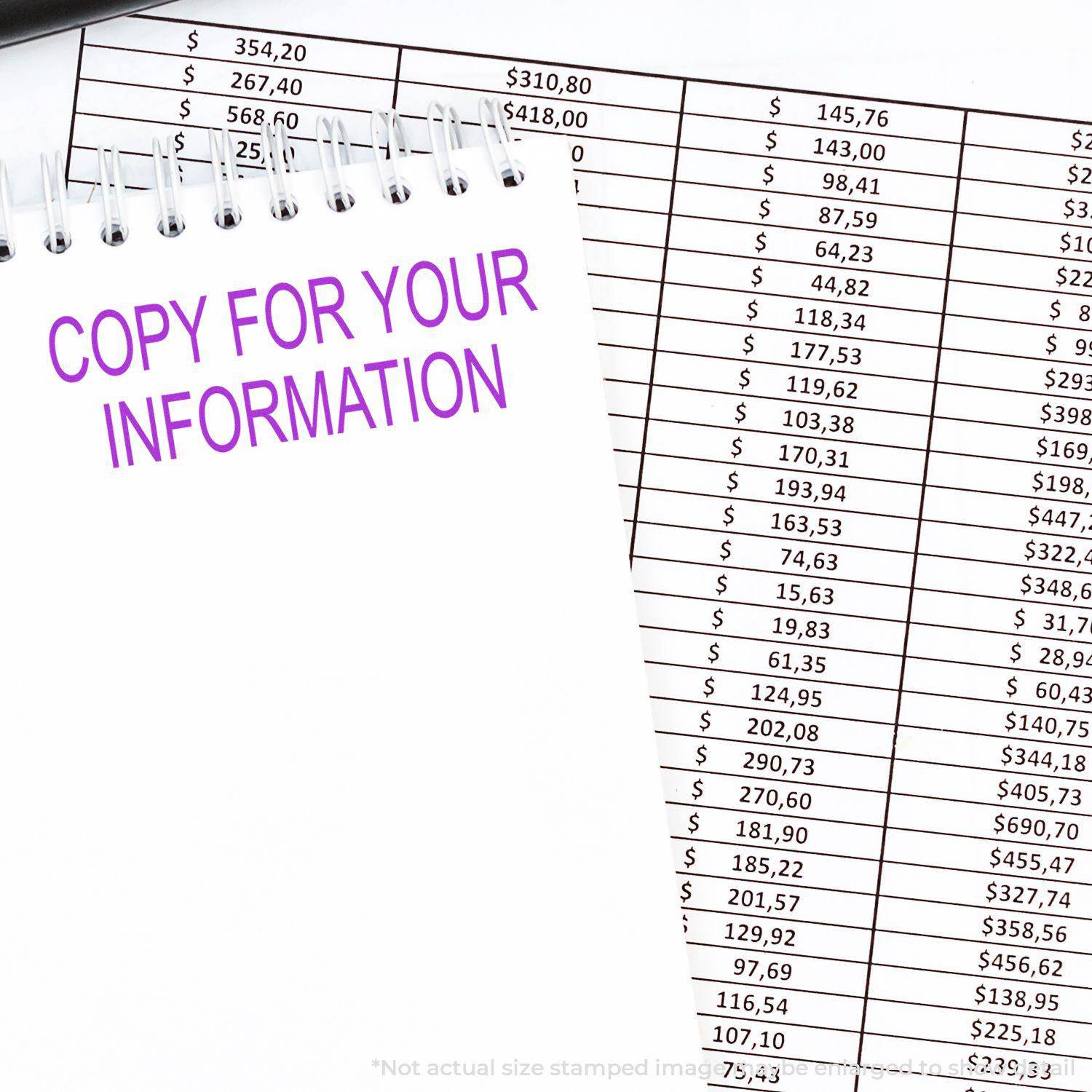 Large Pre-Inked Copy For Your Information Stamp used on a notepad next to financial documents, showing clear and bold purple text.