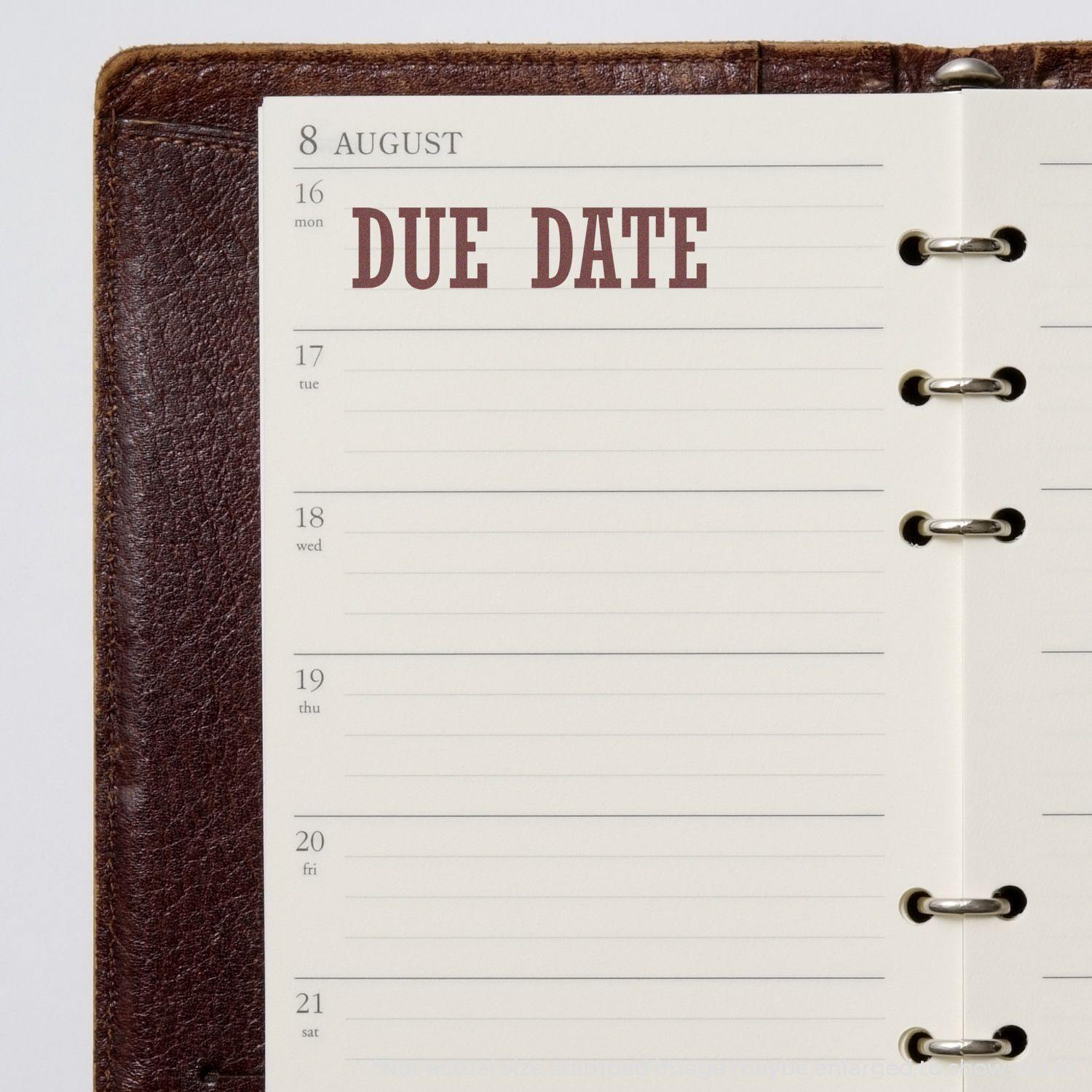 Slim Pre-Inked Due Date Stamp marking 'Due Date' on an open planner page for August 16.