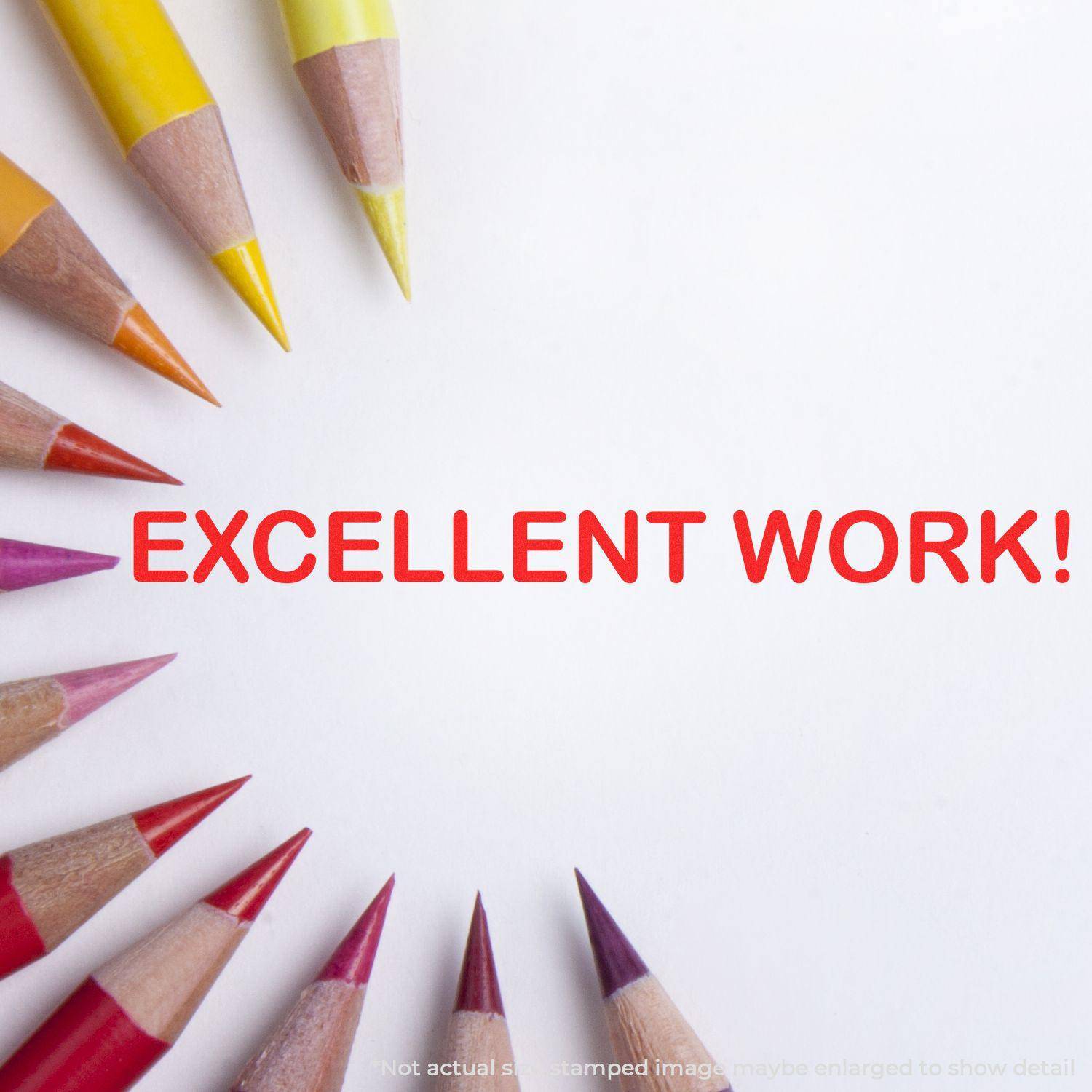 Large Pre-Inked Excellent Work Stamp impression in red on white paper, surrounded by colored pencils arranged in a semi-circle.
