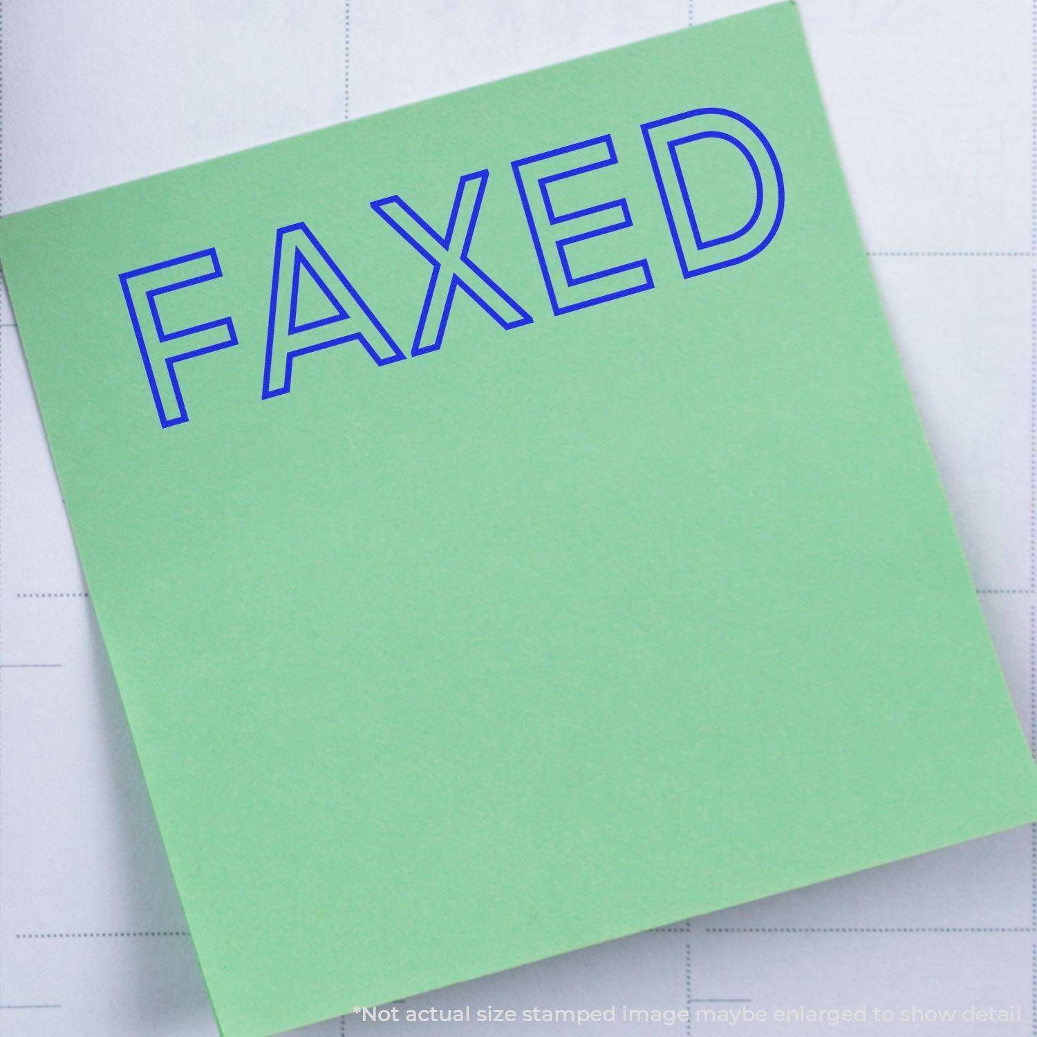 Green paper stamped with FAXED in blue ink using the Large Pre-Inked Faxed Stamp. Note: Image may be enlarged to show detail.