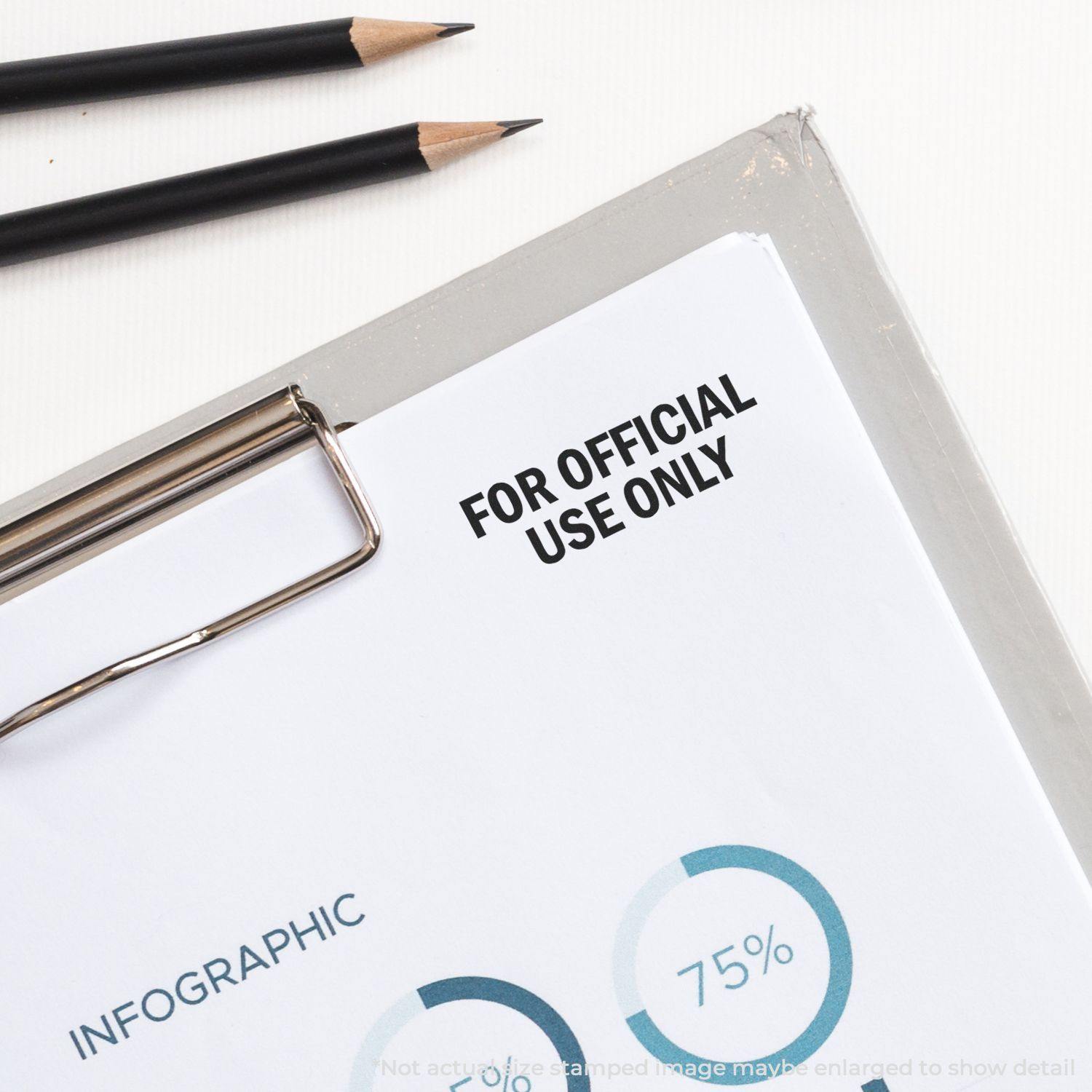Large Self Inking For Official Use Only Stamp marking a document on a clipboard, with pencils nearby.