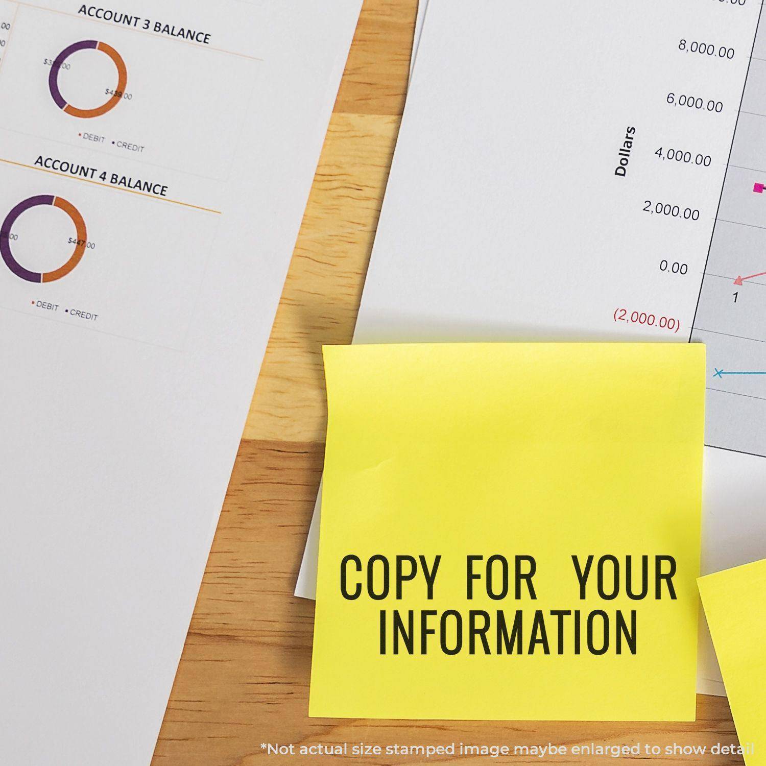 Large Pre-Inked Narrow Copy for your Information Stamp used on a yellow sticky note, placed on a desk with financial documents.