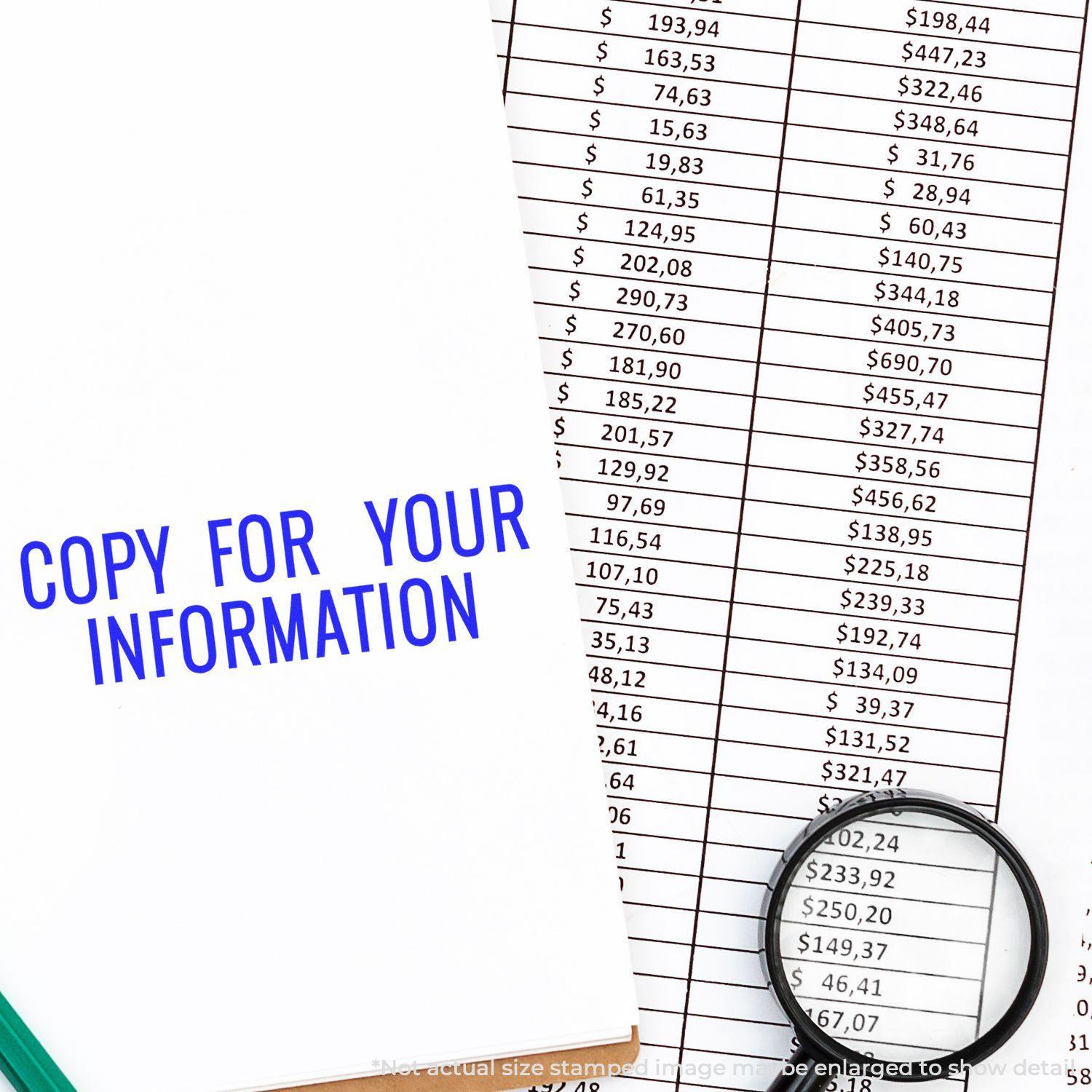 Slim Pre-Inked Narrow Copy for your Information Stamp used on a document beside a magnifying glass and a financial spreadsheet.