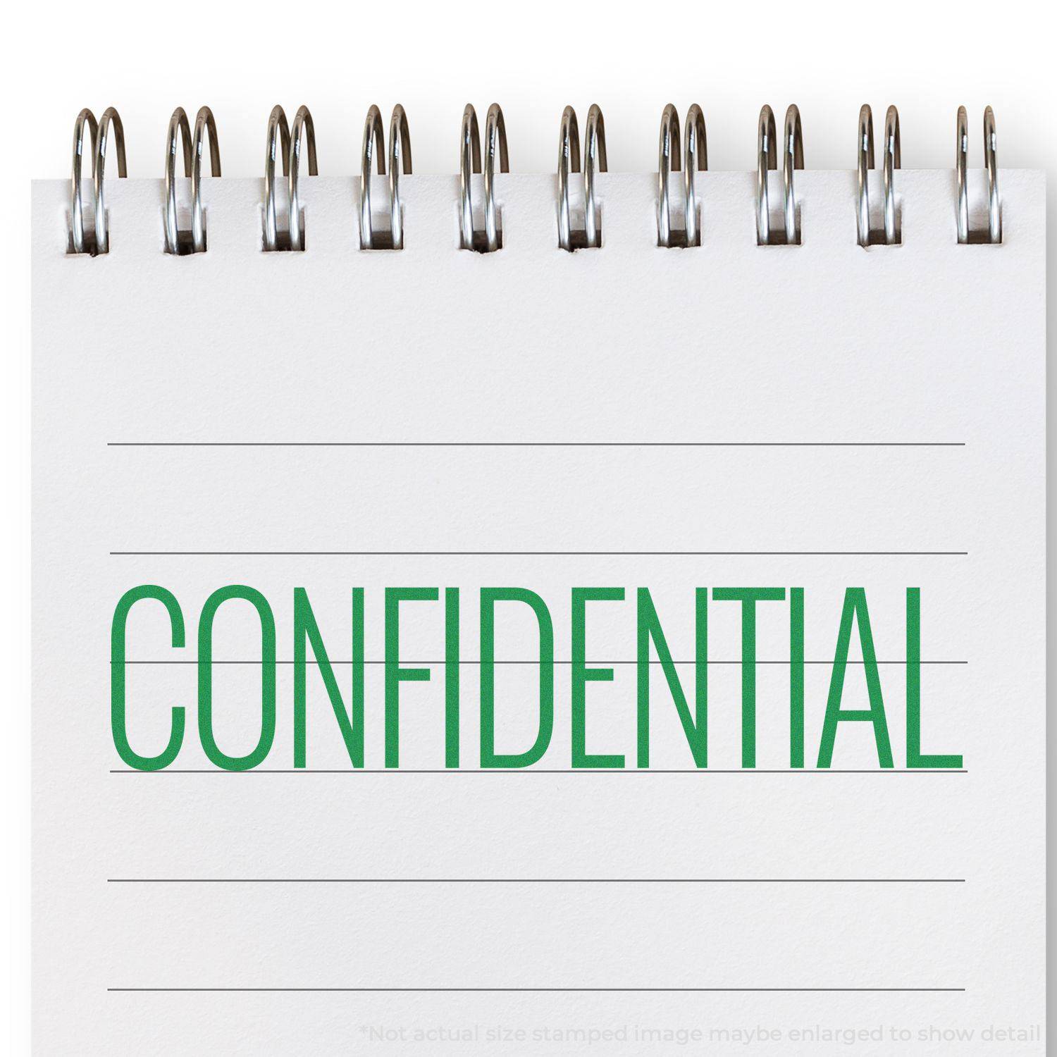 Large Pre-Inked Narrow Font Confidential Stamp in green ink on a spiral notebook, clearly marking the page as CONFIDENTIAL.