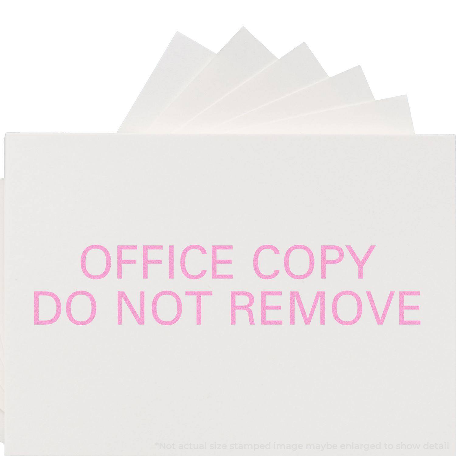 Large Pre-Inked Office Copy Do Not Remove Stamp in use, showing pink text OFFICE COPY DO NOT REMOVE on white paper.