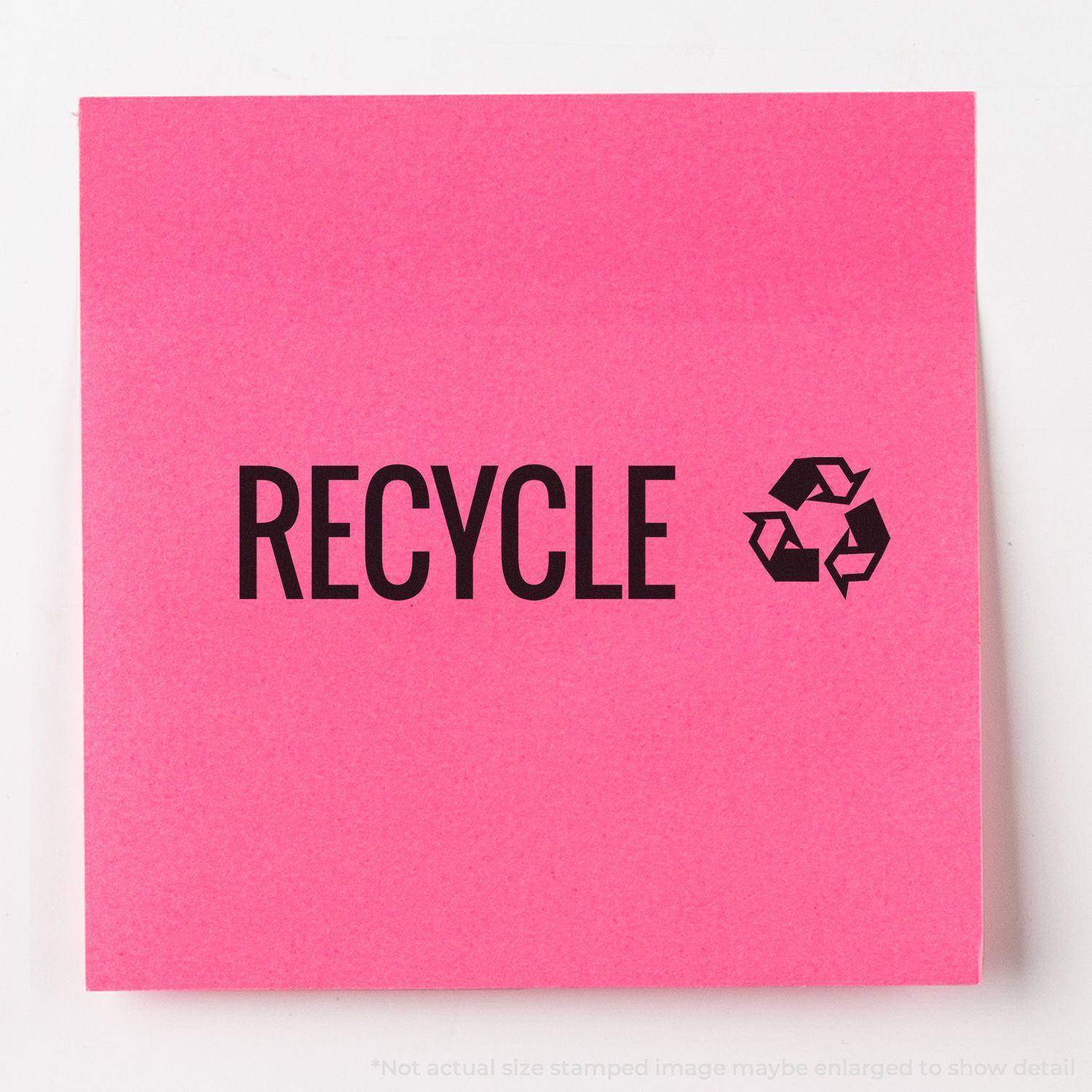 Large Pre-Inked Recycle with Logo Stamp used on a pink sticky note, displaying the word RECYCLE and a recycling symbol.