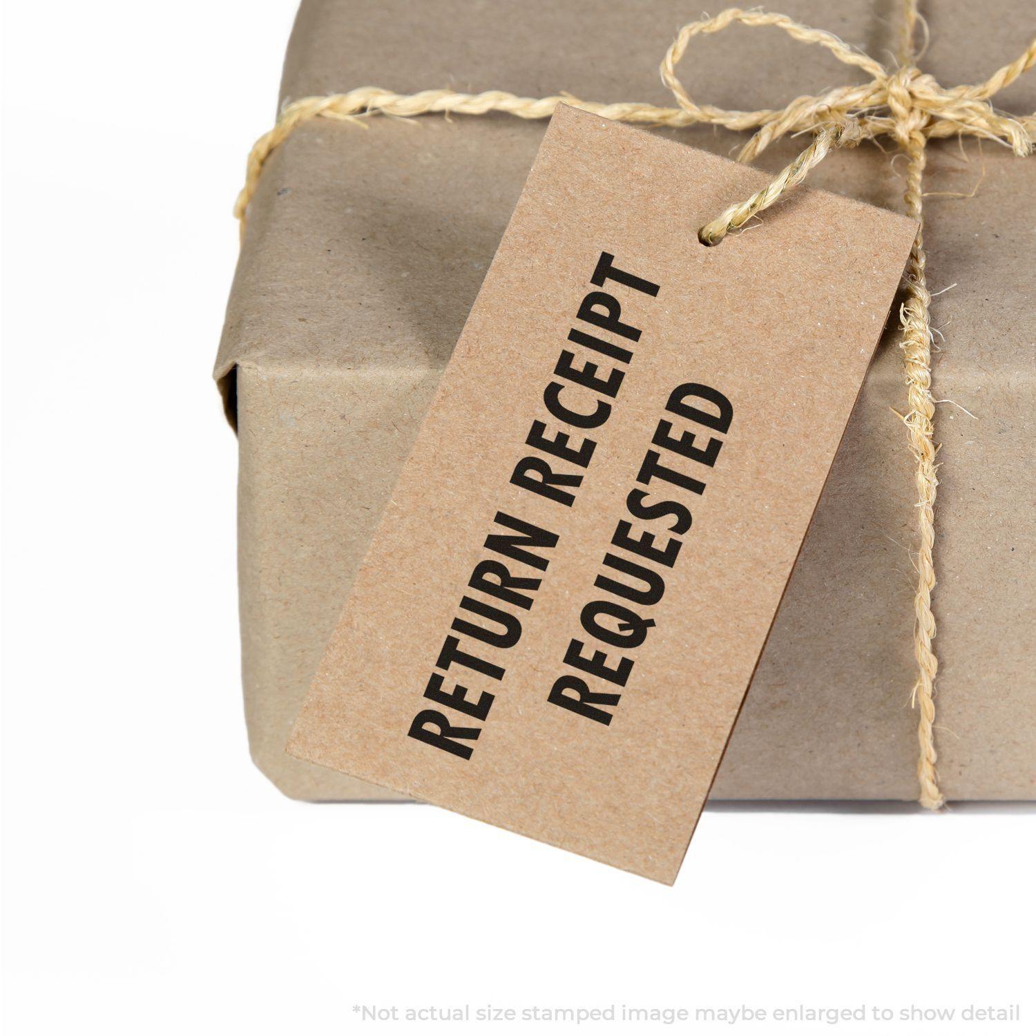 Return Receipt Requested rubber stamp on a brown tag attached to a wrapped package with twine.