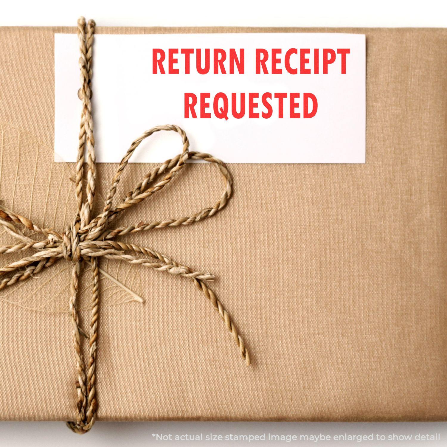 Return Receipt Requested rubber stamp on a brown wrapped package with twine, emphasizing the need for a return receipt.