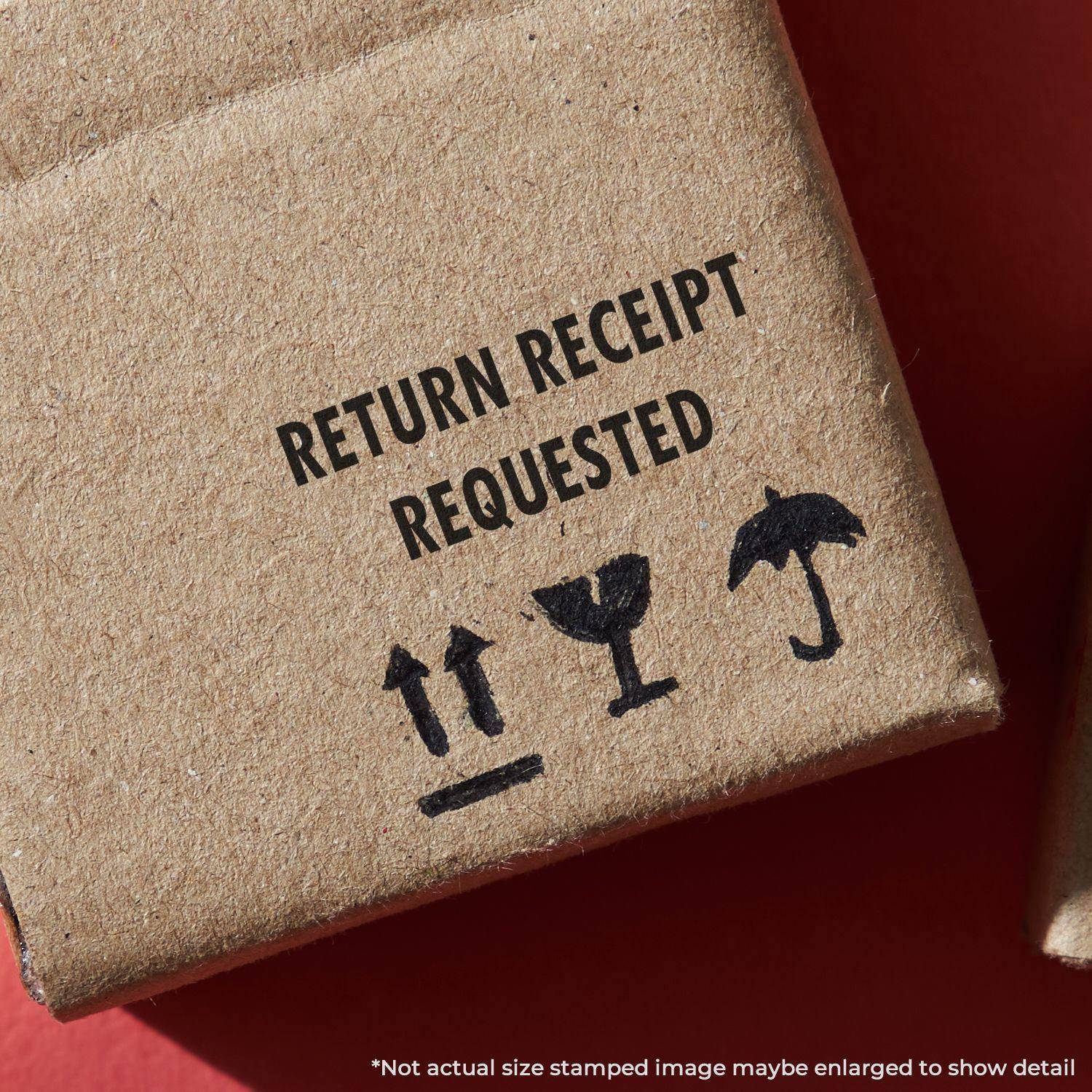 Large Pre-Inked Return Receipt Requested Stamp used on a cardboard box, showing clear and bold text with handling symbols.