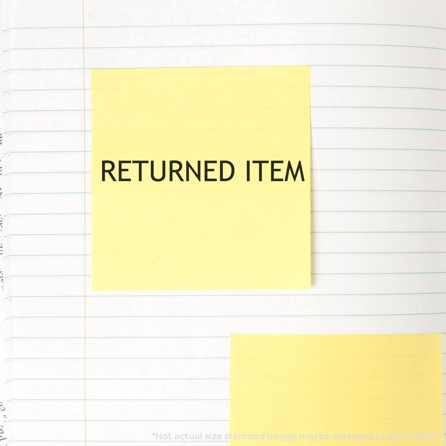 Large Returned Item Rubber Stamp used on a yellow sticky note placed on a lined notebook page.