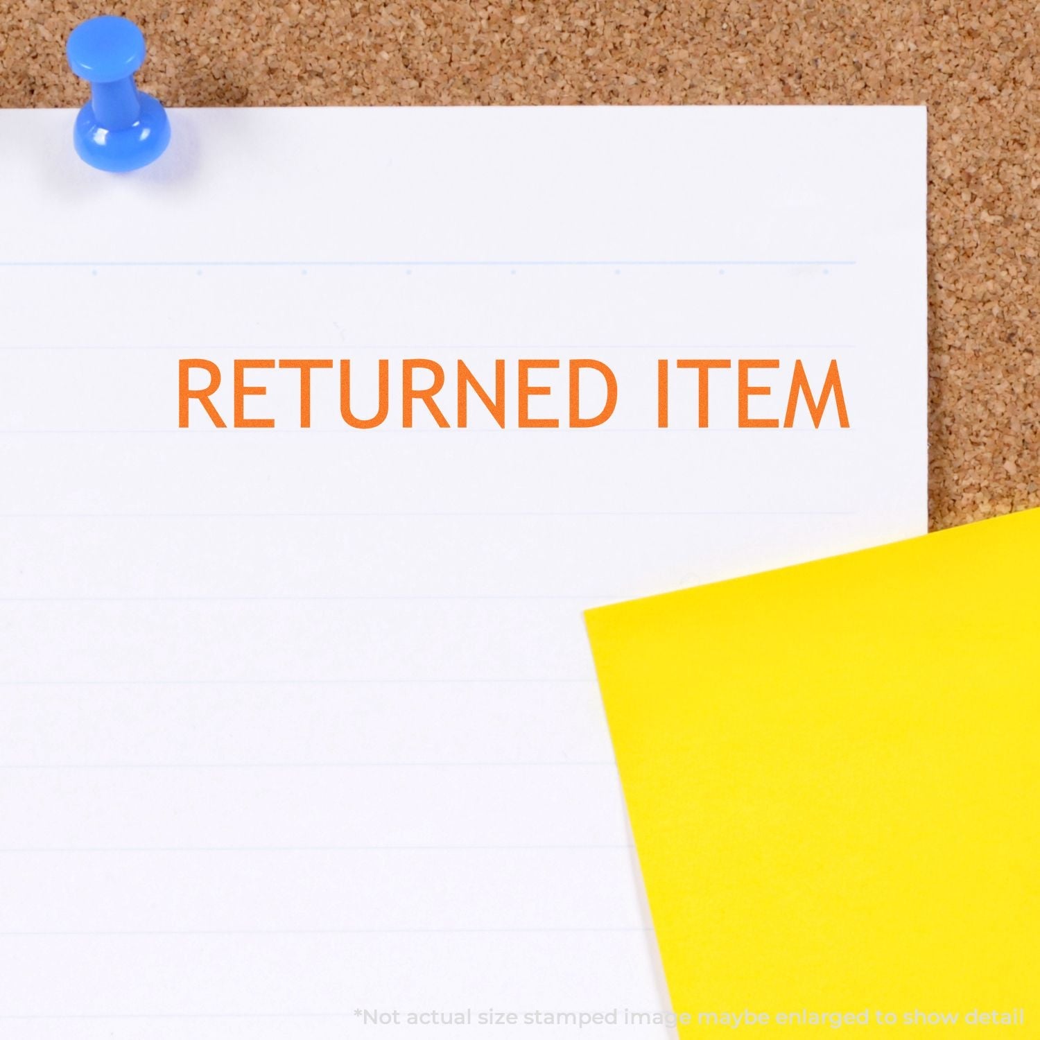 Self Inking Returned Item Stamp marking RETURNED ITEM on a white paper pinned to a corkboard with a blue pushpin and a yellow note.