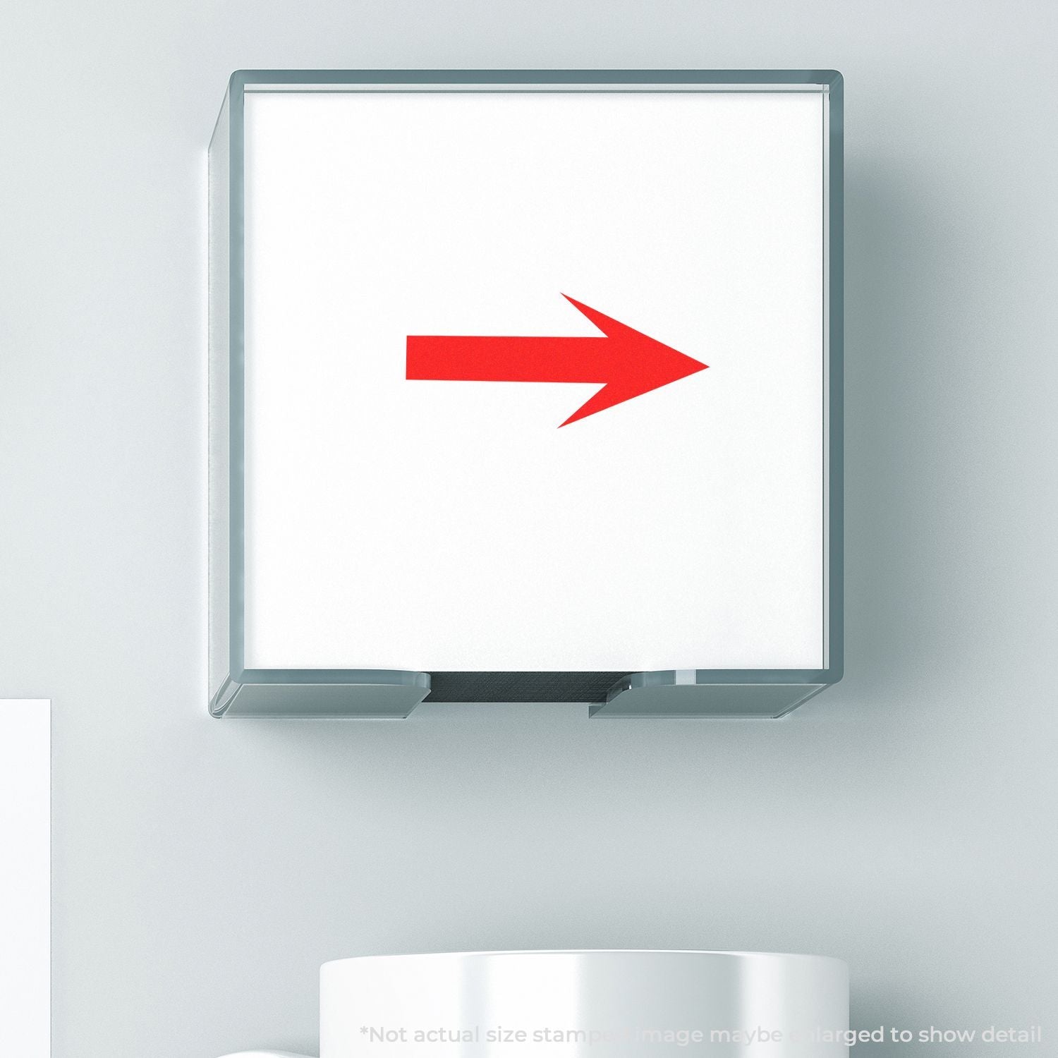 Self Inking Round Arrow Stamp with a red arrow design, shown in use. The stamp is placed on a white surface next to a white mug.