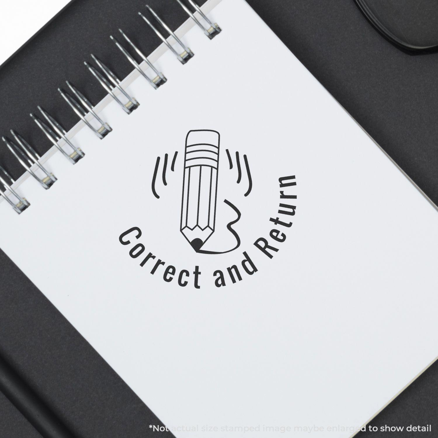A notebook with a Round Correct and Return rubber stamp featuring a pencil design on a white page.