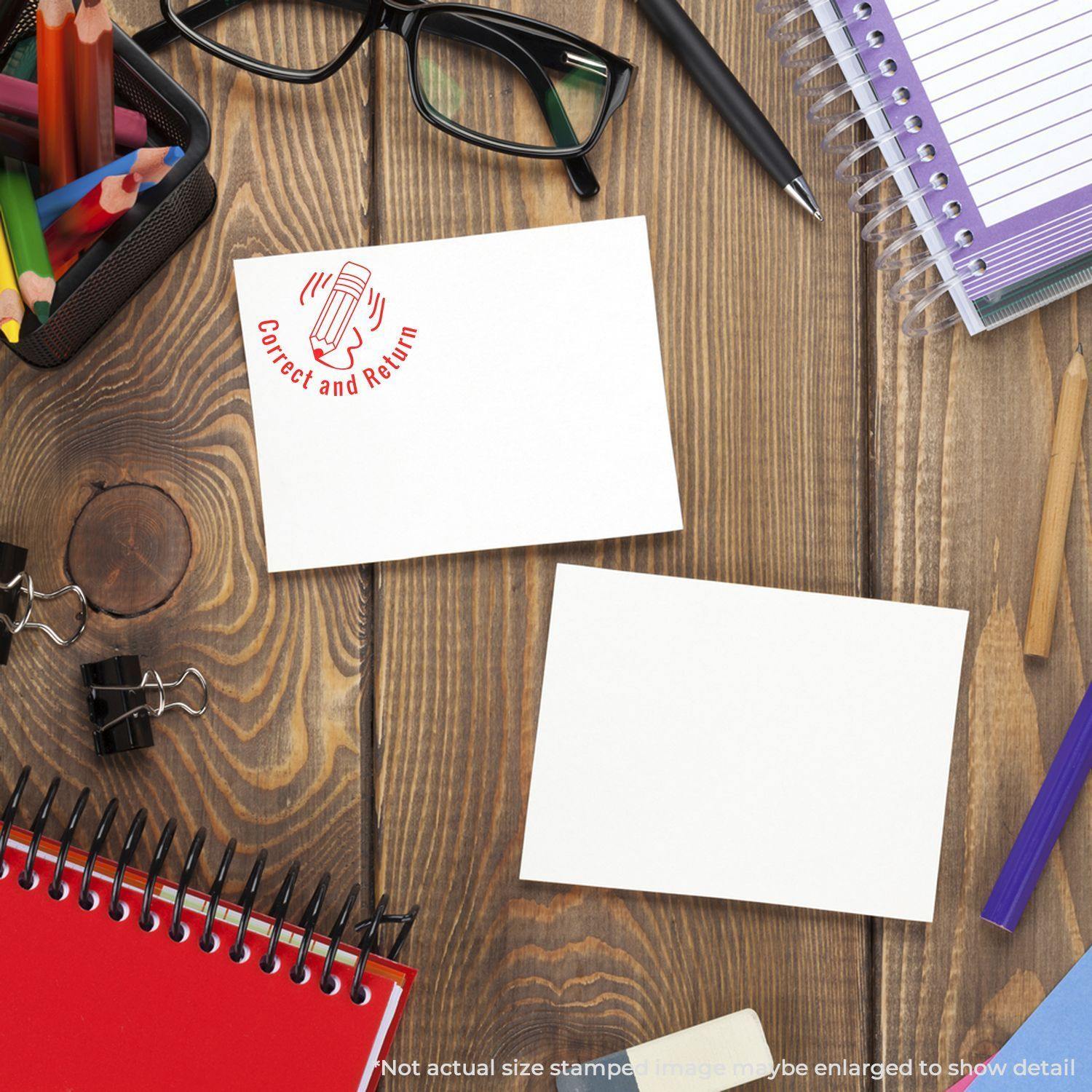 Desk with stationery items and a paper stamped with a round Correct and Return rubber stamp in red ink.