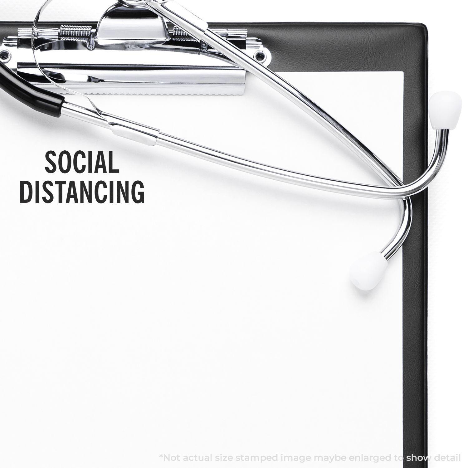 Clipboard with a stethoscope and a large social distancing rubber stamp imprint on a blank sheet of paper.