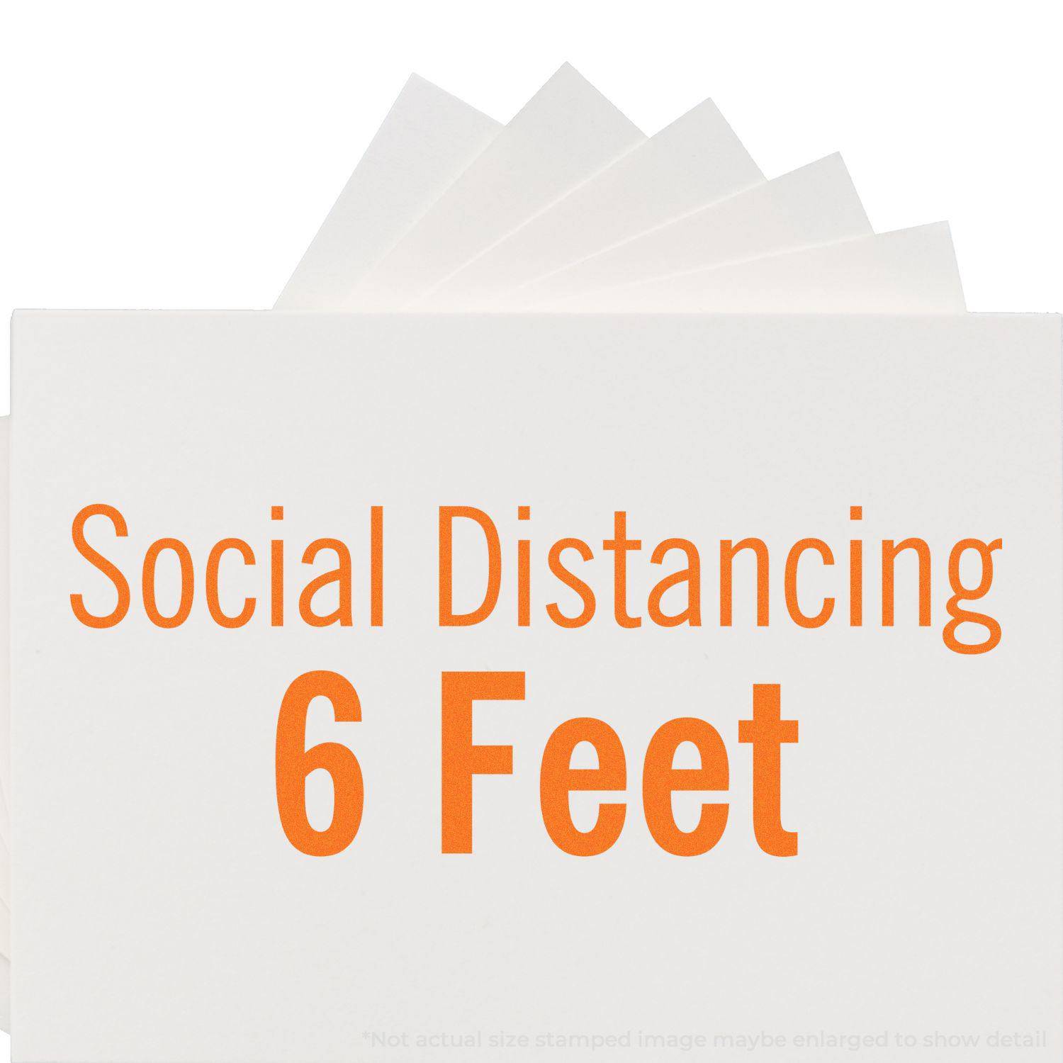 Large Pre-Inked Social Distancing 6 Feet Stamp in use, showing the bold orange text Social Distancing 6 Feet on a white background.