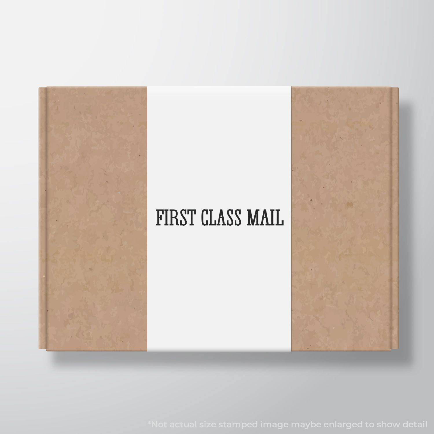 Large Pre-Inked Times First Class Mail Stamp used on a brown package, displaying FIRST CLASS MAIL in black text on a white label.