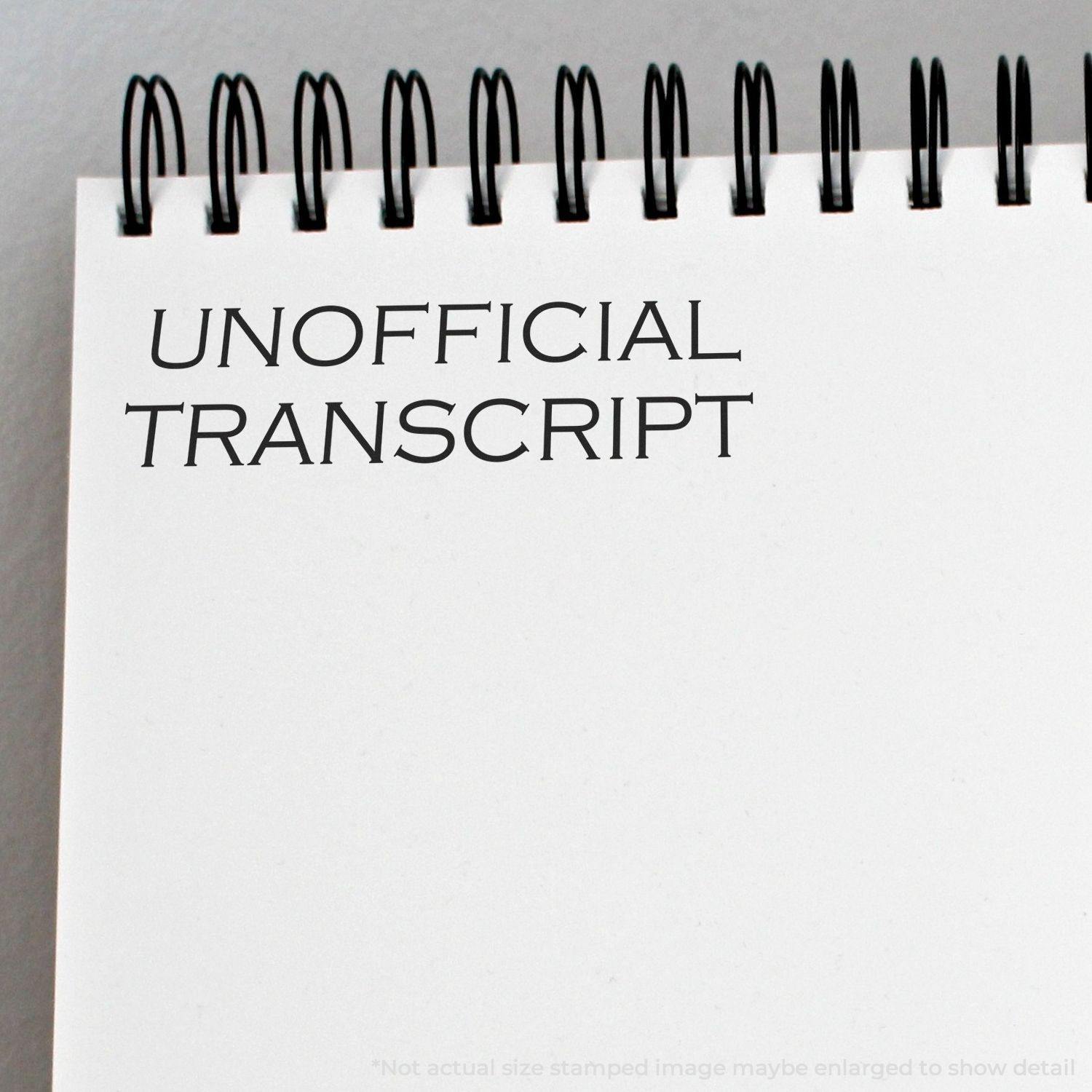 Spiral-bound notebook with Unofficial Transcript rubber stamp impression on a blank page.