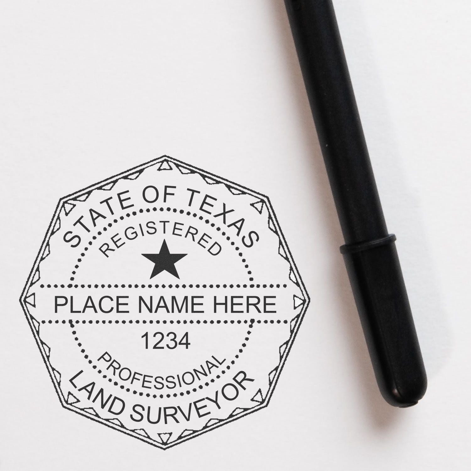 Premium MaxLight Pre-Inked Texas Surveyors Stamp imprint on paper, with a black pen beside it.