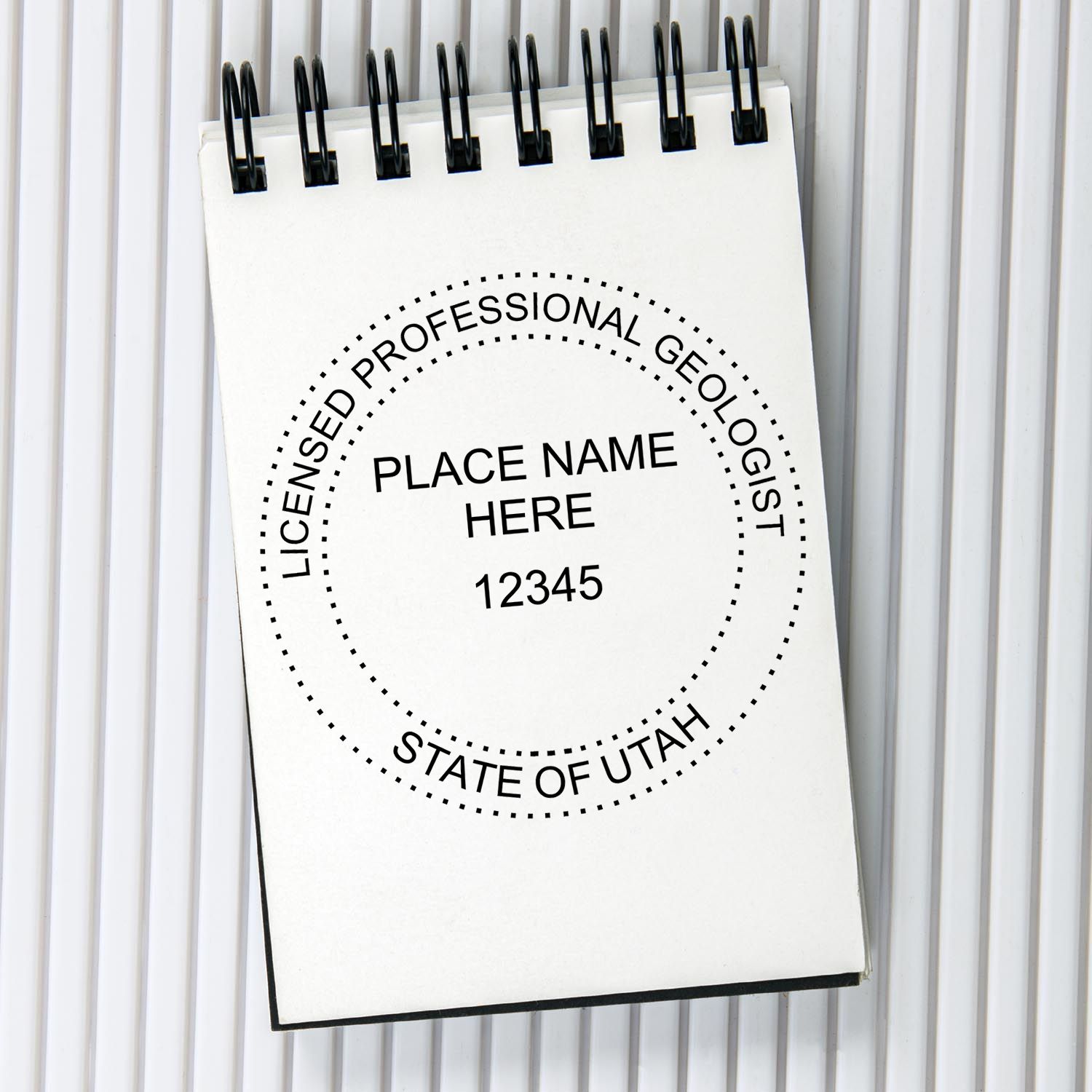 A lifestyle photo showing a stamped image of the Self-Inking Utah Geologist Stamp on a piece of paper