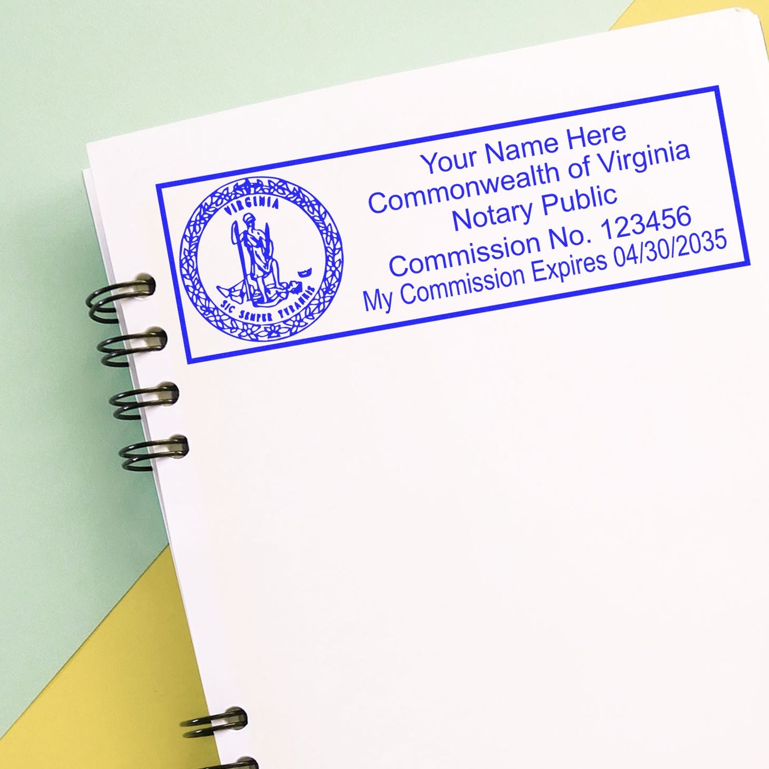A self-inking stamp with a stamped image showing how your name, commission number, and expiration date with a round Virginia seal image on the left will appear after stamping from this notary stamp.