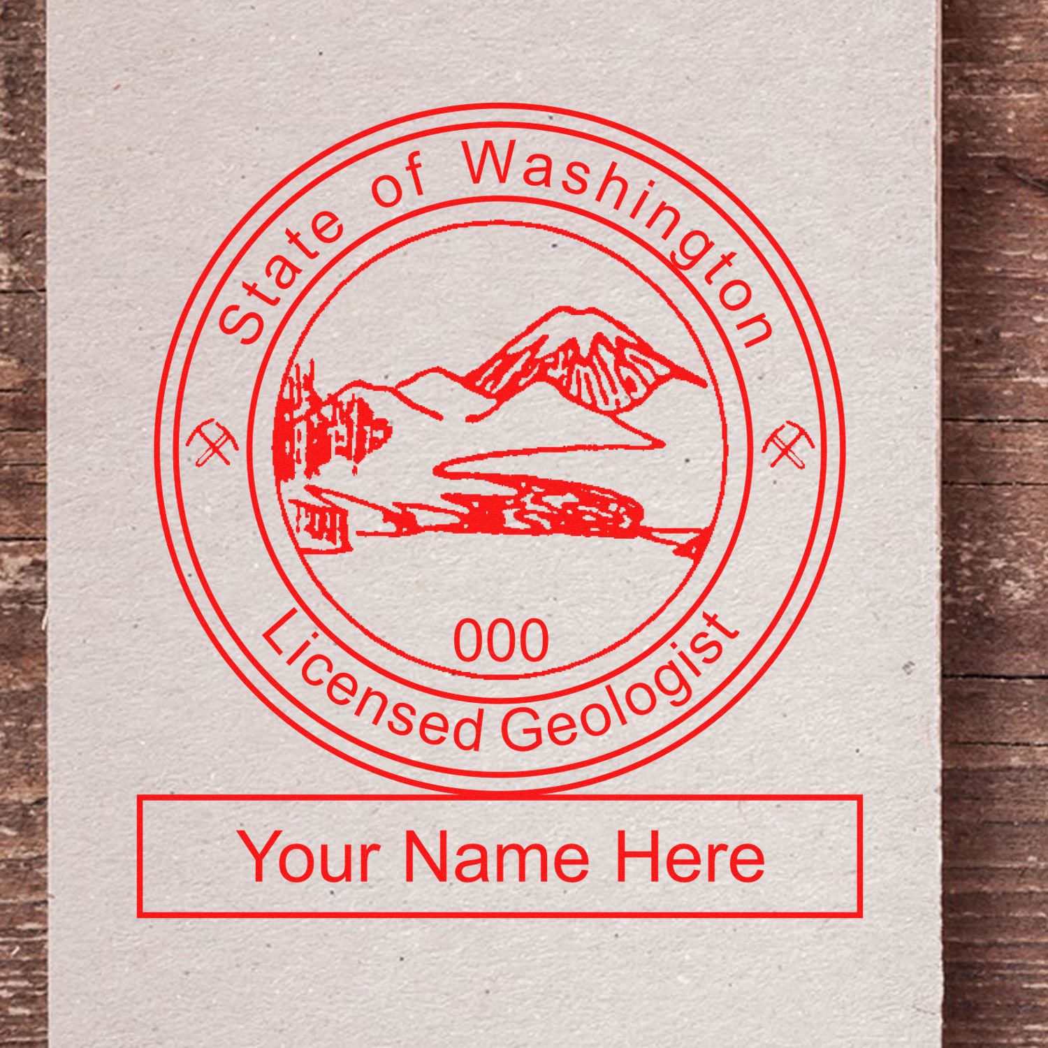 An in use photo of the Washington Professional Geologist Seal Stamp showing a sample imprint on a cardstock