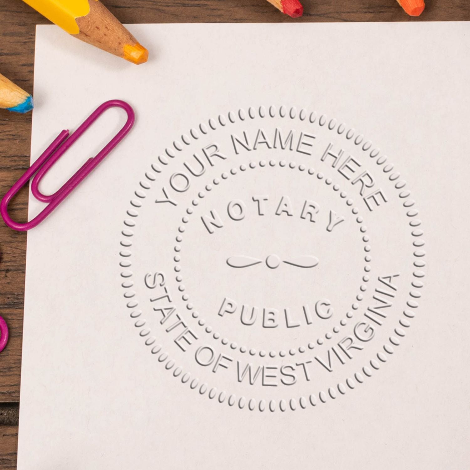 A stamped impression of the West Virginia Handheld Notary Seal Embosser in this stylish lifestyle photo, setting the tone for a unique and personalized product.