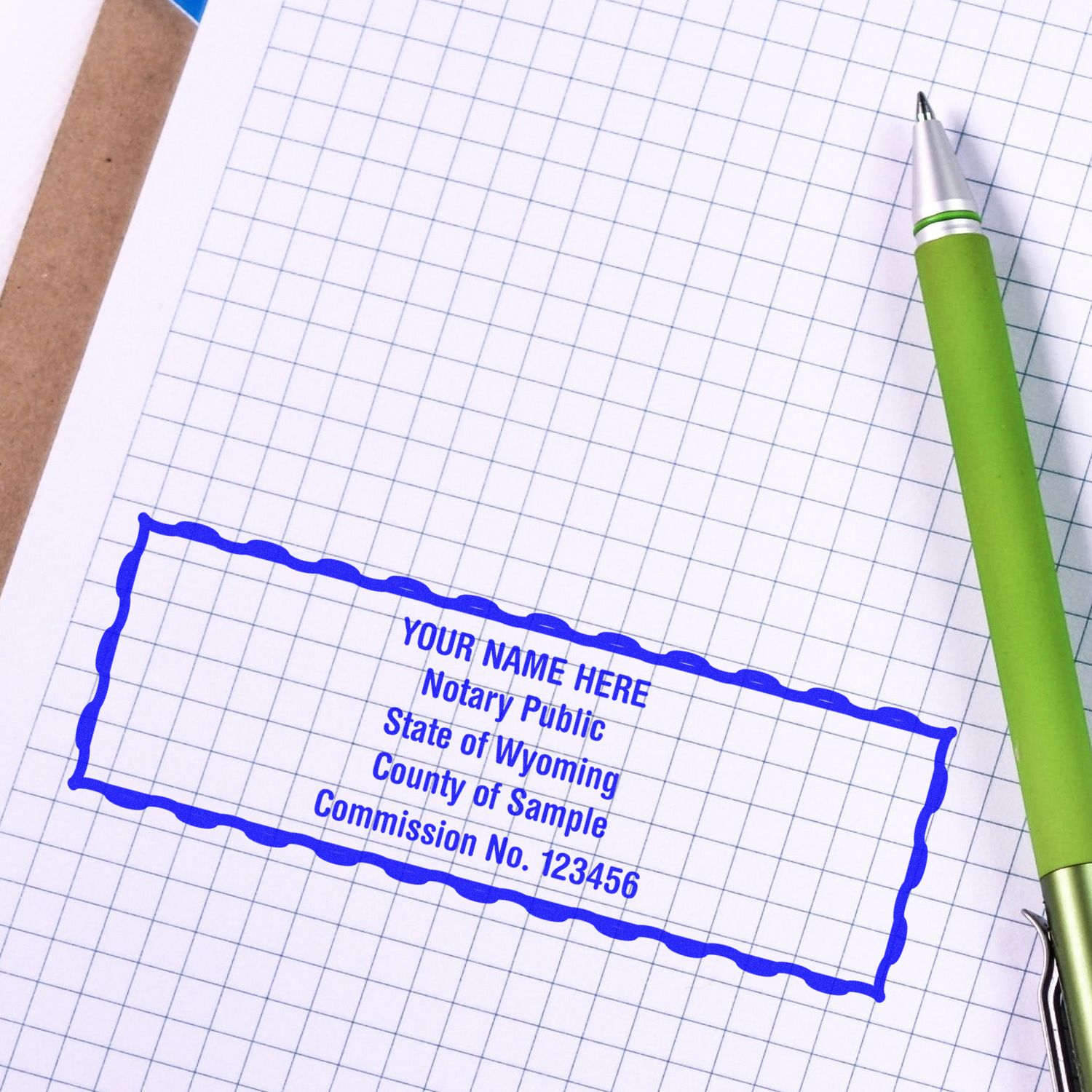 A lifestyle photo showing a stamped image of the Wyoming Rectangular Digital Notary Seal on a piece of paper