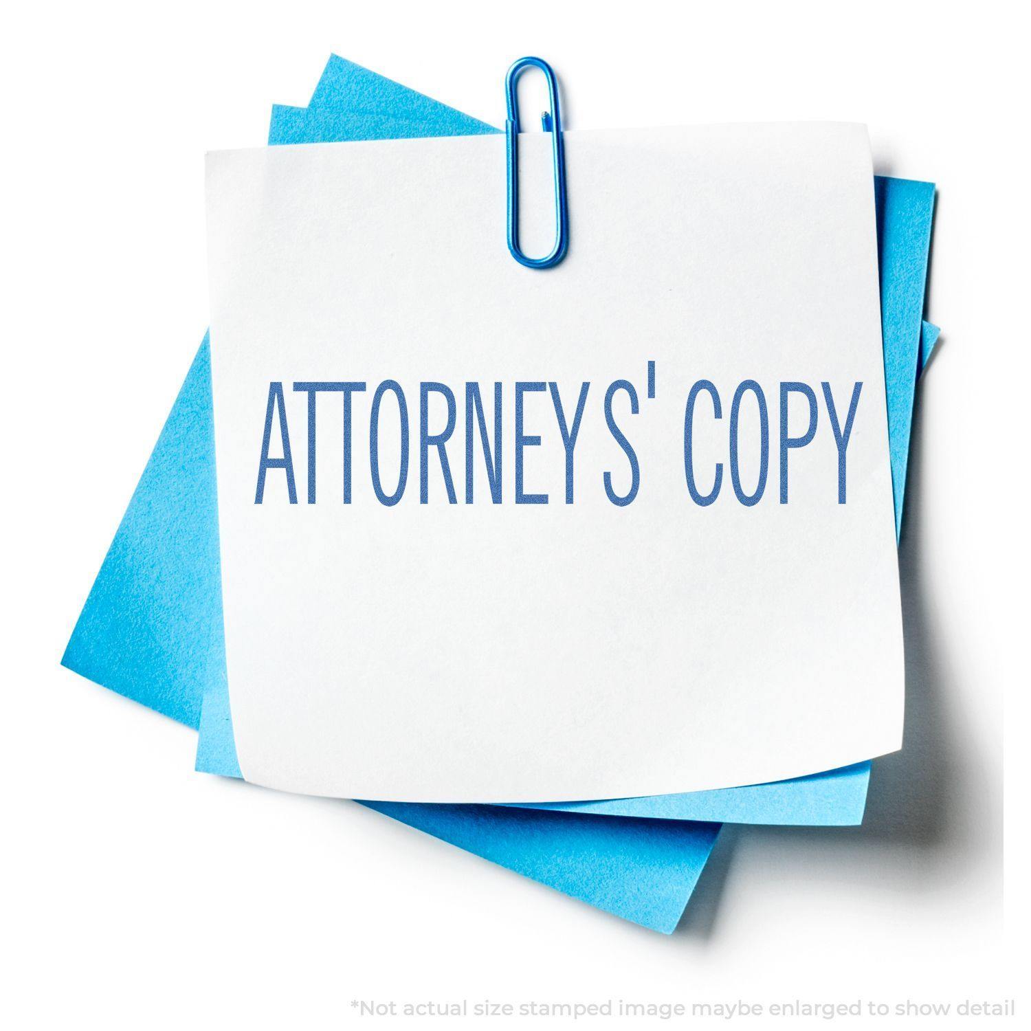 Attorney's Copy Xstamper Stamp imprint on a white paper clipped to blue sheets, showcasing clear and professional stamping results.