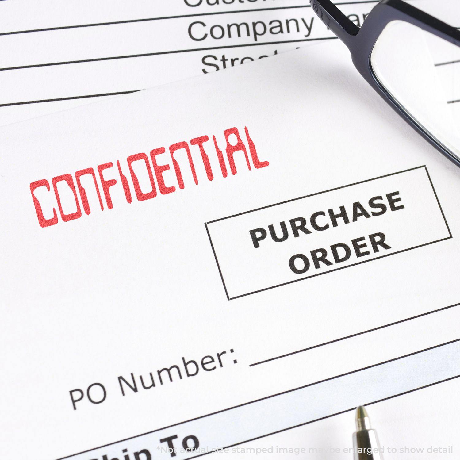 A document stamped with CONFIDENTIAL using the Barcode Confidential Xstamper Stamp, with a purchase order form and glasses in the background.