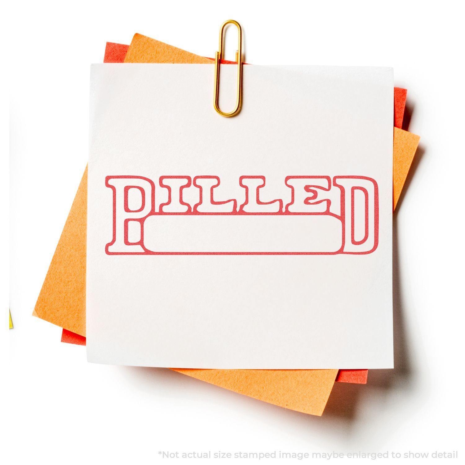 Billed Xstamper Stamp imprint on white paper clipped to orange sheets, showcasing the bold red 'BILLED' text with a blank space below.