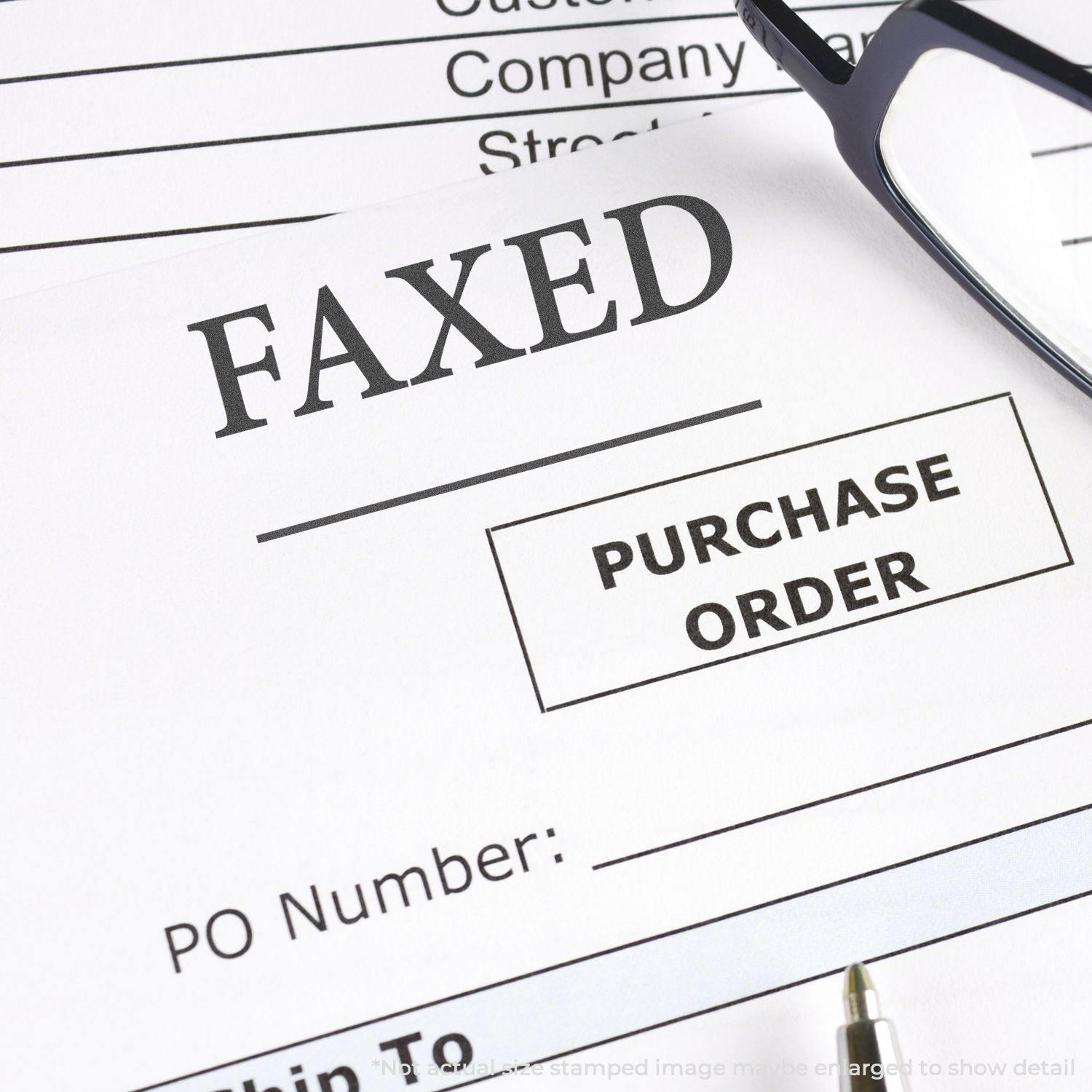 A document stamped with FAXED using the Black Faxed Xstamper Stamp, placed next to glasses and a pen on a desk.