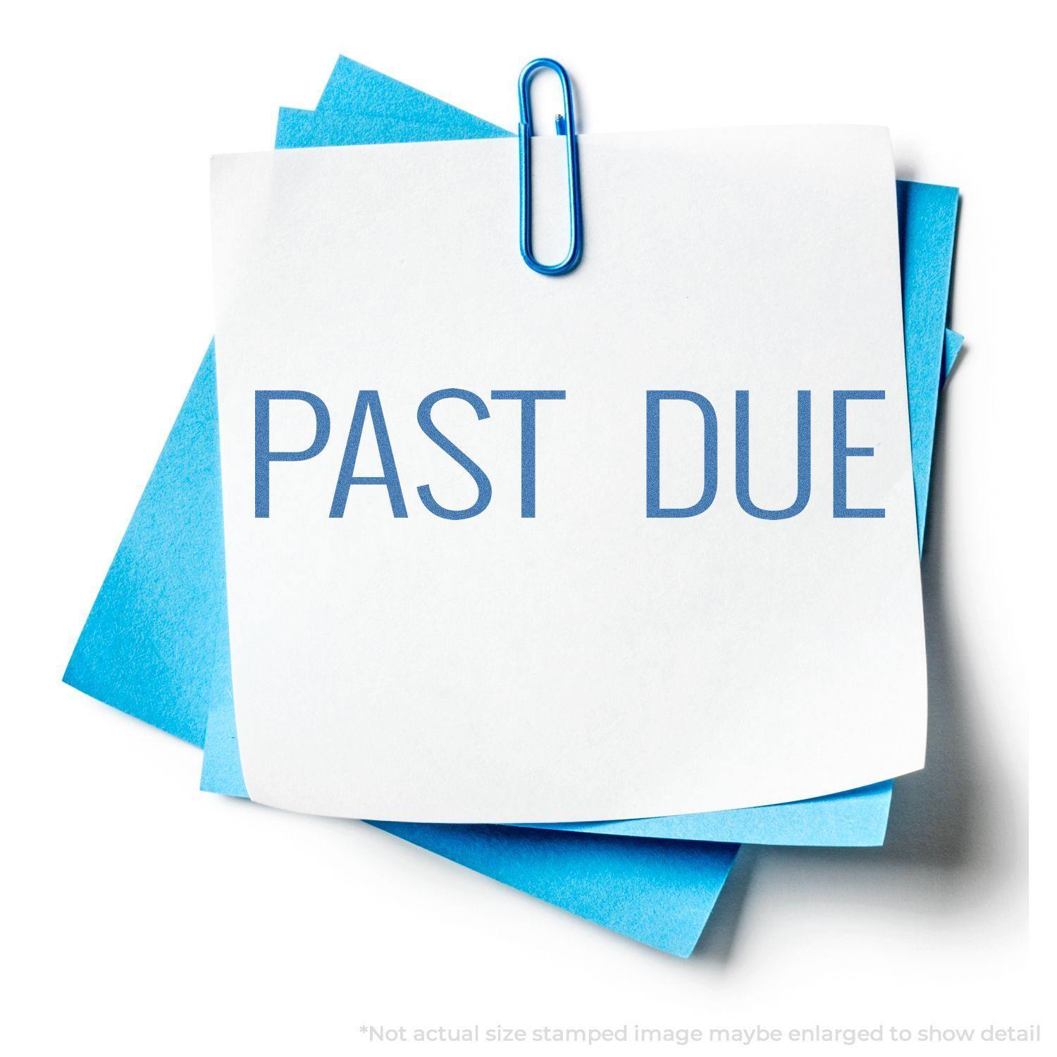 Blue Past Due Xstamper Stamp marking PAST DUE on white paper clipped to blue sheets, indicating overdue status.